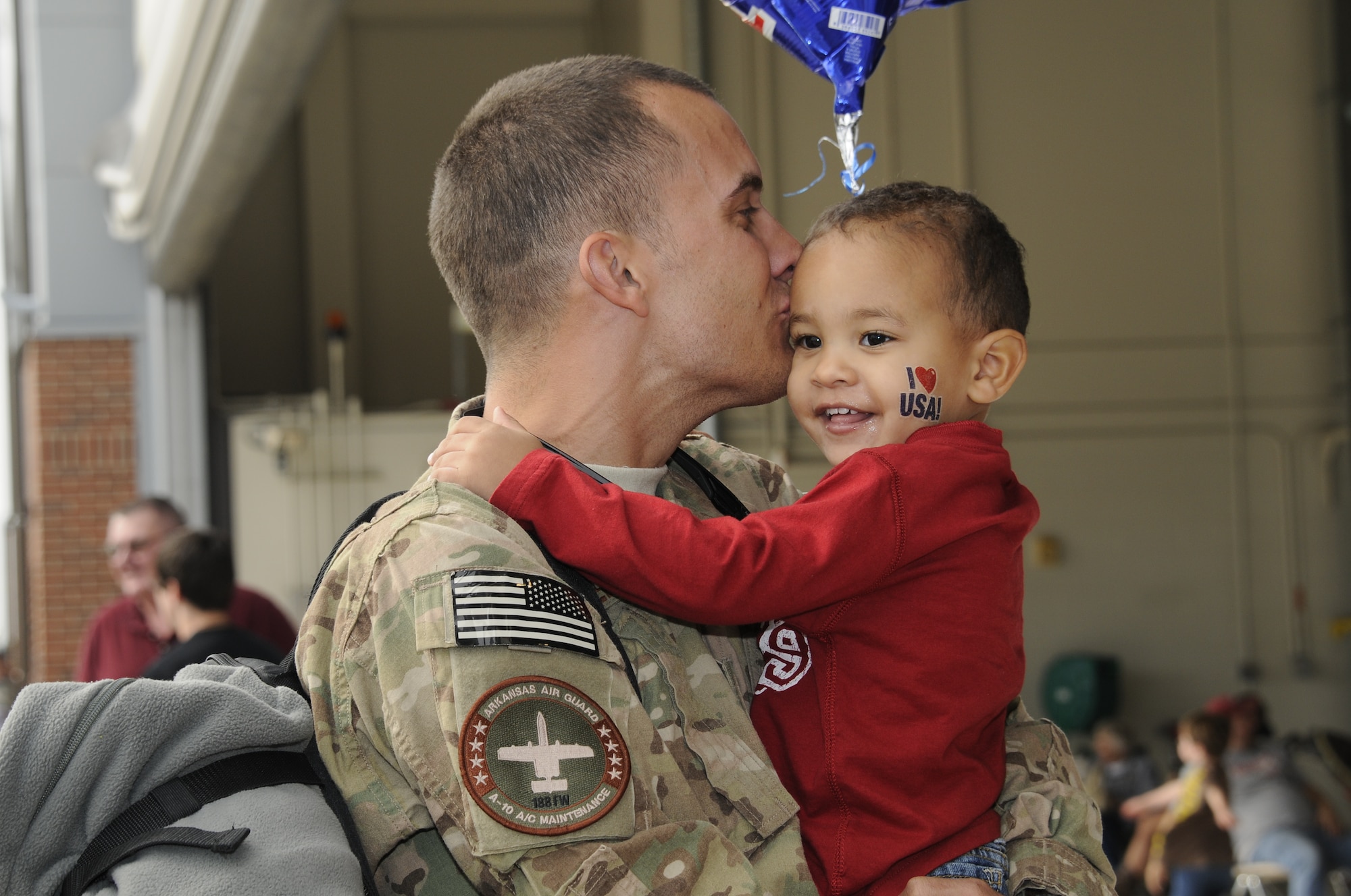 A returning 188th Fighter Wing member kisses his son upon returning from a deployment to Afghanistan Oct. 12, 2012. Approximately 280 Airmen with the 188th Fighter Wing returned to Fort Smith, Ark., from a deployment to Bagram Airfield, Afghanistan Oct. 12. (National Guard photo by Senior Airman Hannah Landeros/188th Fighter Wing Public Affairs)