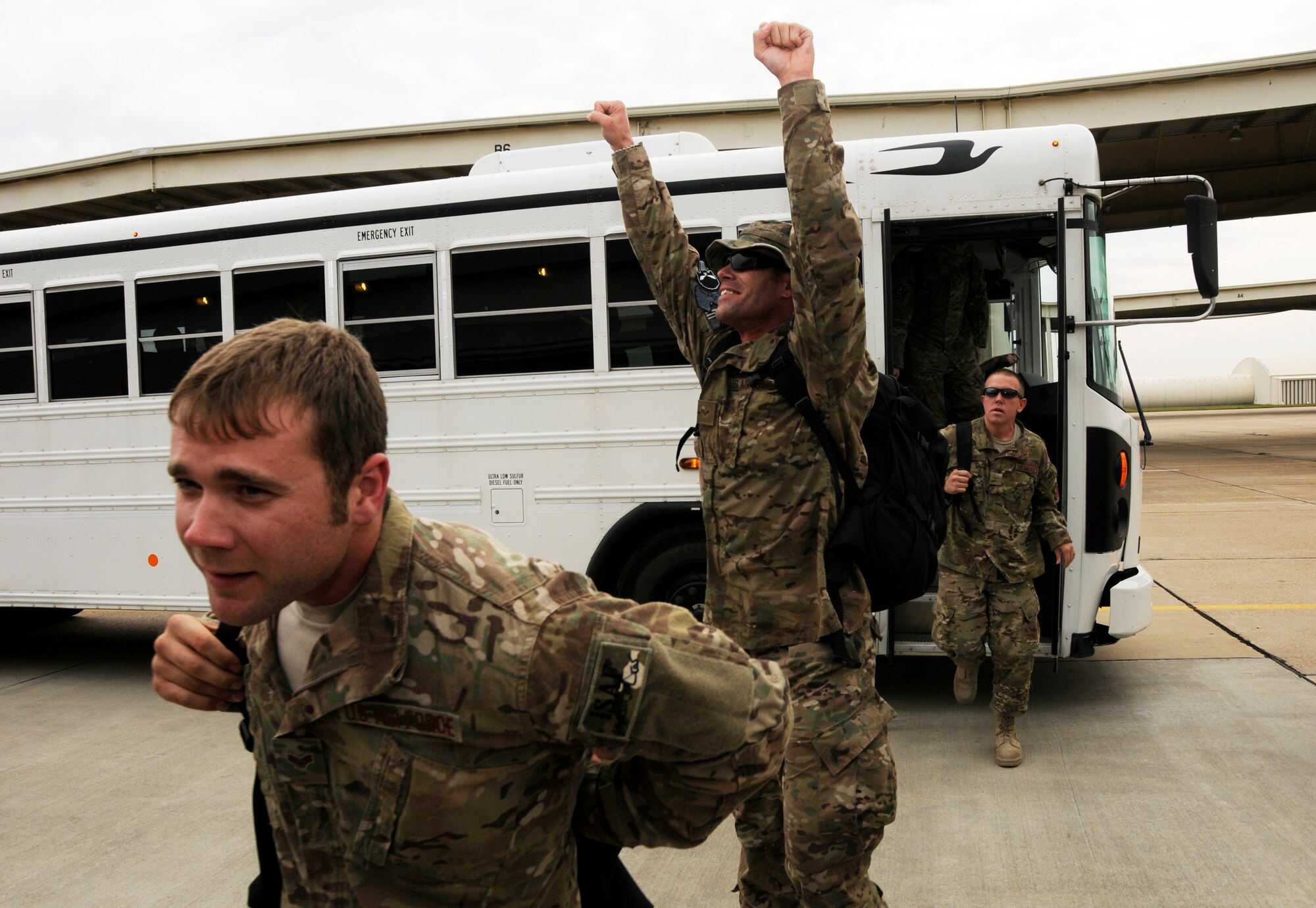 Airman 1st Class Phillip Parker lifts his hands in the air to celebrate stepping on Arkansas soil Oct. 12, 2012. Approximately 280 Airmen with the 188th Fighter Wing returned to Fort Smith, Ark., from a deployment to Bagram Airfield, Afghanistan Oct. 12. (National Guard photo by Airman Cody Martin/188th Fighter Wing Public Affairs)