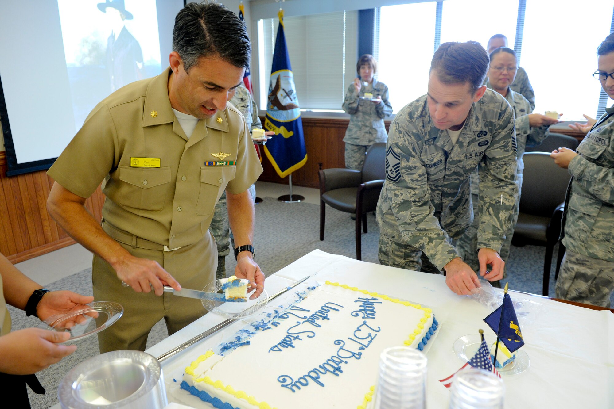 VANDENBERG AIR FORCE BASE, Calif. -- Lt. Cmdr. Christopher Papaioanu, a Joint Functional Component Command for Space operations officer, serves the  cake during the U.S. Navy's 237th Birthday celebration here Friday, Oct 12, 2012. Currently a modern force of 287 ships and more than 3,700 aircraft, our Navy was created in 1775 with the establishment of the Continental Navy to sail against British merchant ships. (U.S. Air Force photo/Staff Sgt. Levi Riendeau)
