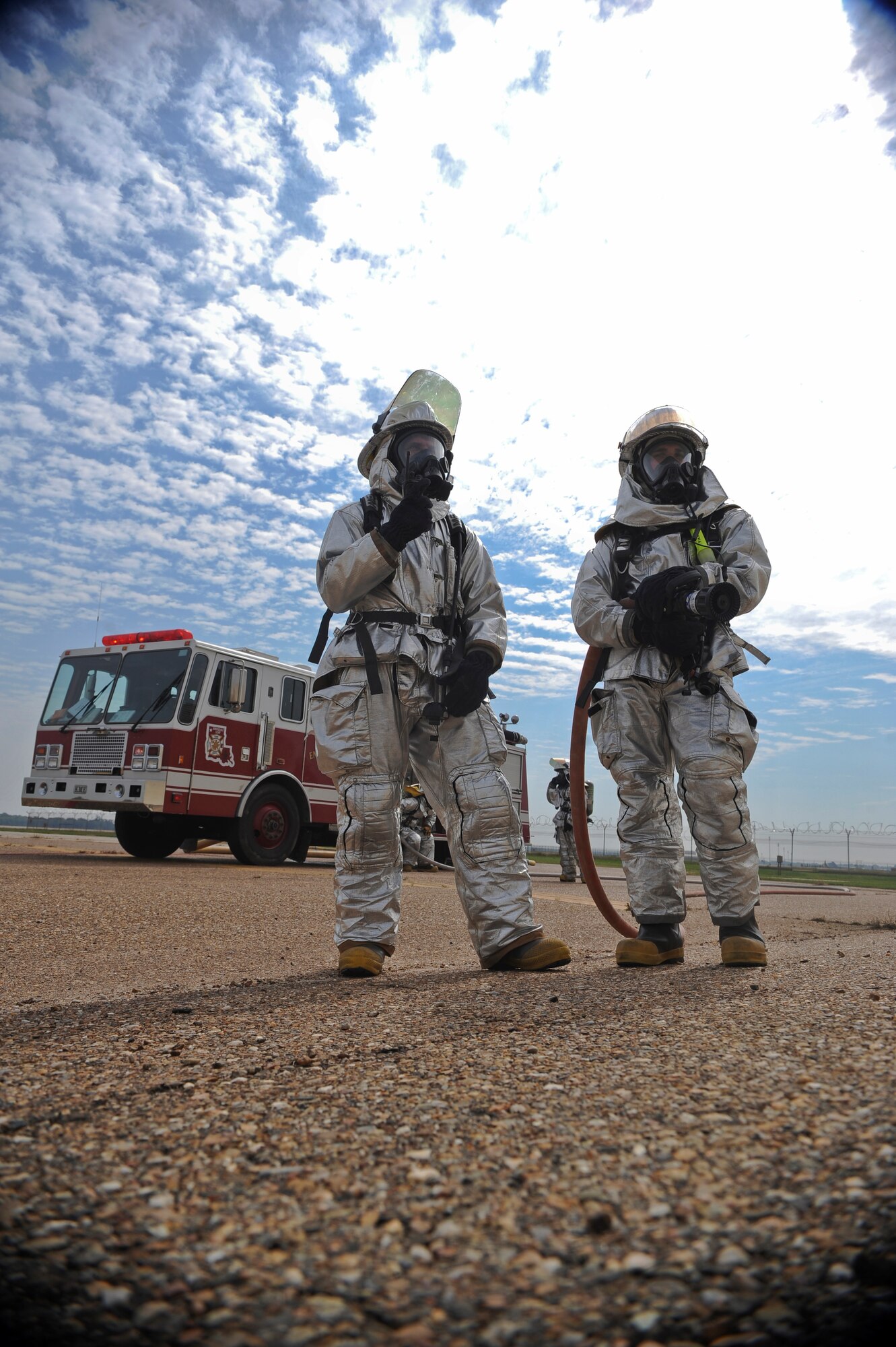 Firefighters wait outside of a cordoned area during a major accident response exercise on Barksdale Air Force Base, La., Oct. 12. In this scenario, Airmen were exposed to a simulated hazardous substance in the Warrior Center's dining facility. Firefighters, security forces, emergency management, bioenvironmental and medical Airmen and civilians worked together to ensure the building was safe and secure. (U.S. Air Force photo/Senior Airman Micaiah Anthony)(RELEASED)