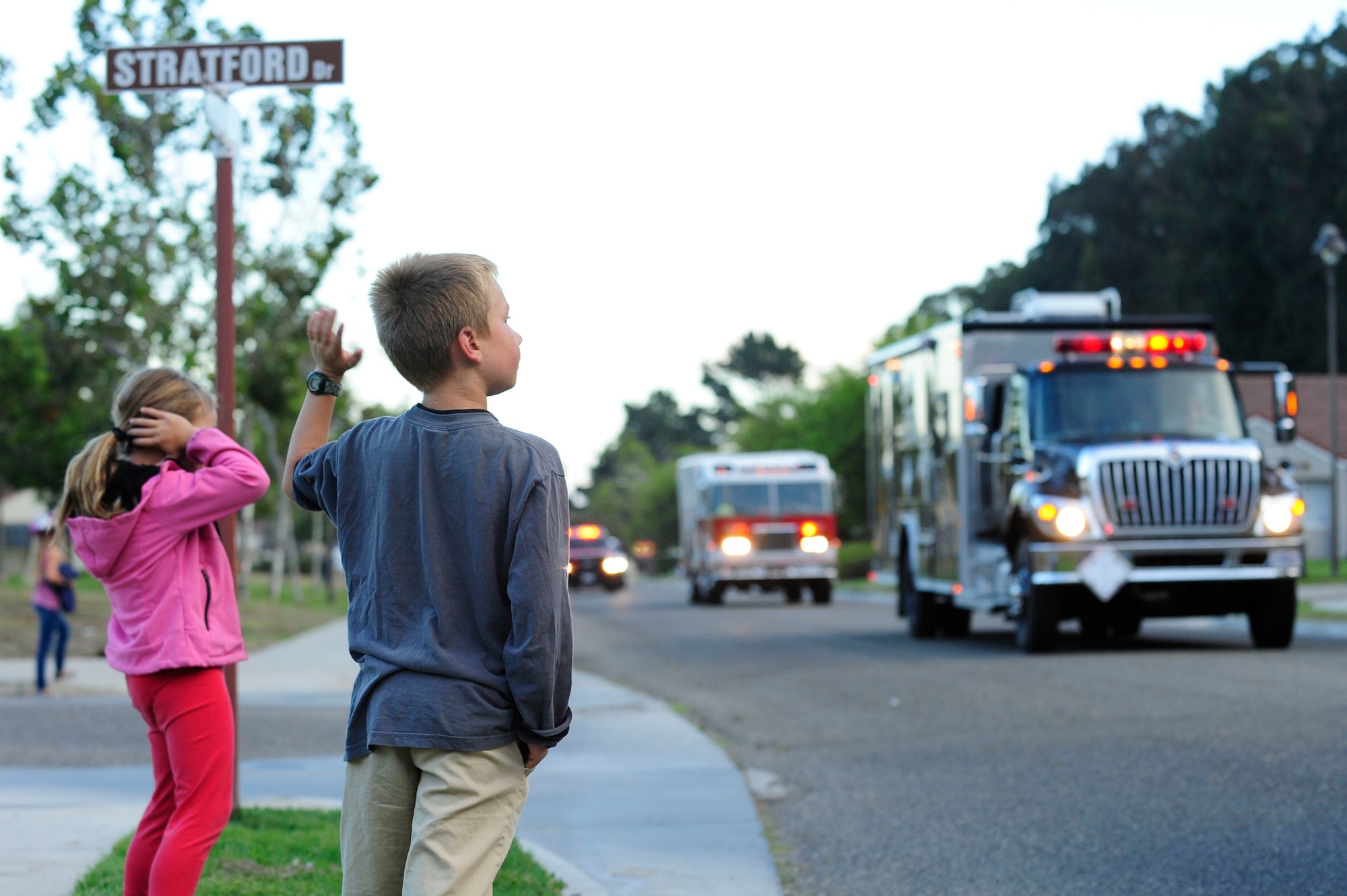 VANDENBERG AIR FORCE BASE, Calif. – Children cover their ears as the sirens wail during the final leg of the Fire Prevention Parade down Magnolia Street here Thursday evening, Oct. 11, 2012. The Fire Prevention Parade was one of the key events the Vandenberg Fire Department hosted during Fire Prevention Week Oct. 7-13. (U.S. Air Force photo/Senior Airman Lael Huss)