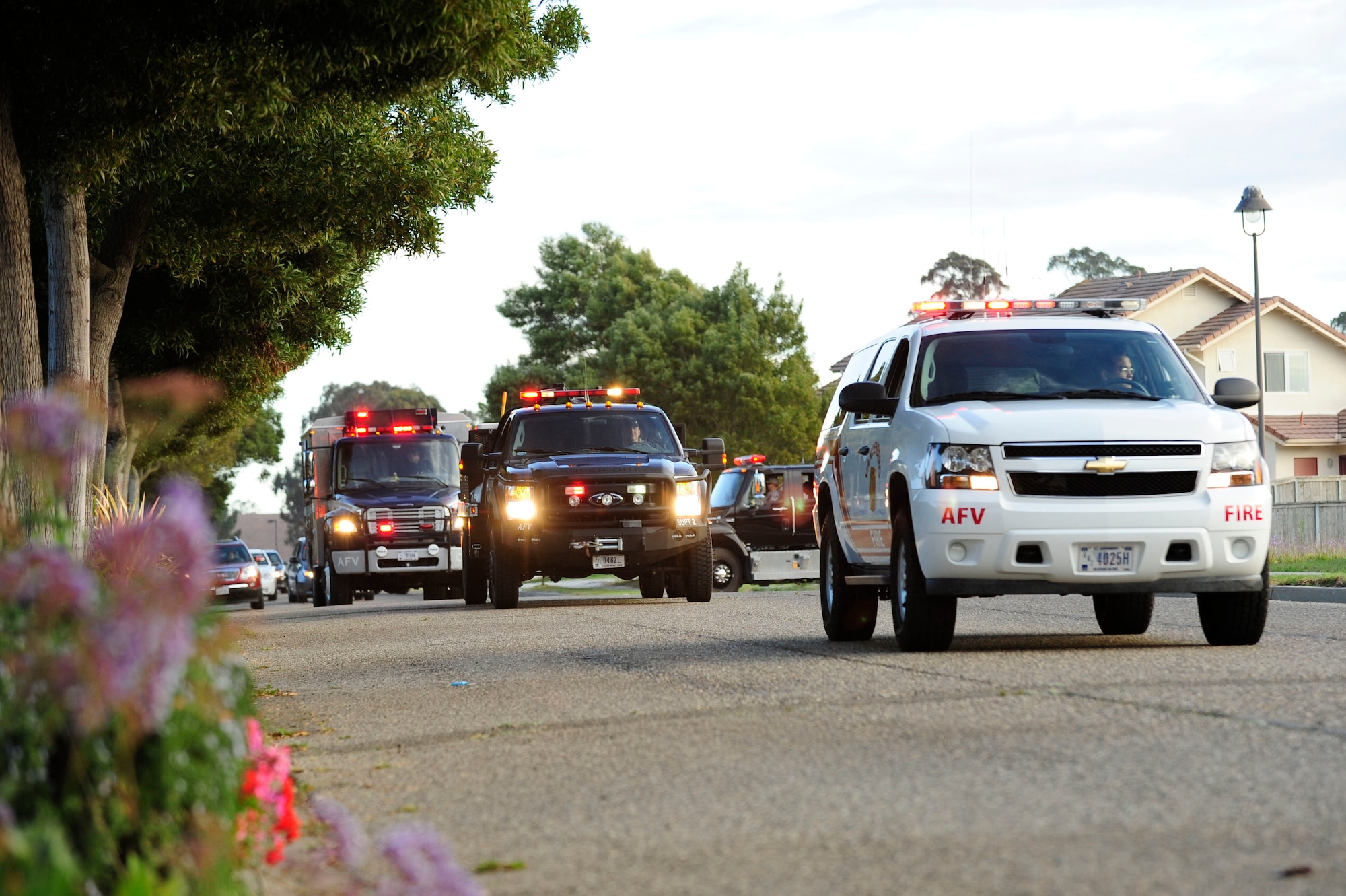 VANDENBERG AIR FORCE BASE, Calif. – Emergency vehicles parade down Ocean View Avenue at a slow pace tossing candy to families lining the streets in base housing during the Fire Prevention Parade here Thursday evening, Oct. 11, 23012. The Fire Prevention Parade was one of the key events the Vandenberg Fire Department hosted during Fire Prevention Week Oct. 7-13. (U.S. Air Force photo/Senior Airman Lael Huss)