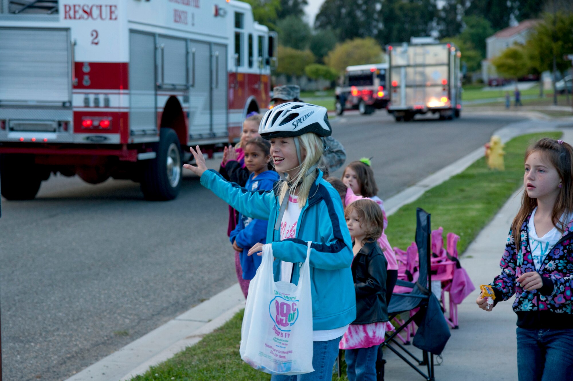 VANDENBERG AIR FORCE BASE, Calif. – Base children wave to the parade vehicles during the final leg of the Fire Prevention Parade here Thursday evening, Oct. 11, 2012. The Fire Prevention Parade was one of the key events the Vandenberg Fire Department hosted during Fire Prevention Week Oct. 7-13. (U.S. Air Force photo/Senior Airman Lael Huss)