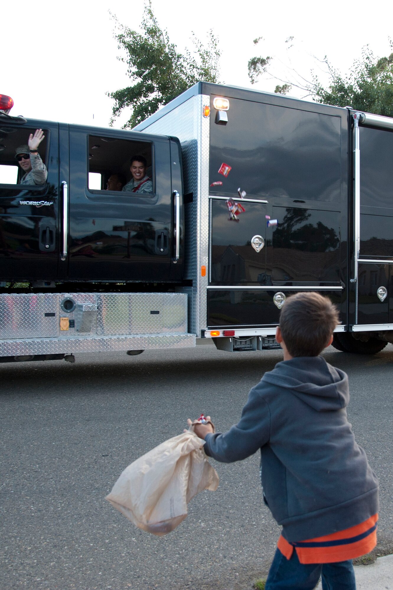 VANDENBERG AIR FORCE BASE, Calif. – A young boy prepares to catch candy thrown from an United States Air Force Explosive Ordinance Disposal emergency vehicle during the Fire Prevention Parade here Thursday evening, Oct. 11, 2012. The Fire Prevention Parade was one of the key events the Vandenberg Fire Department hosted during Fire Prevention Week Oct. 7-13. (U.S. Air Force photo/Senior Airman Lael Huss)