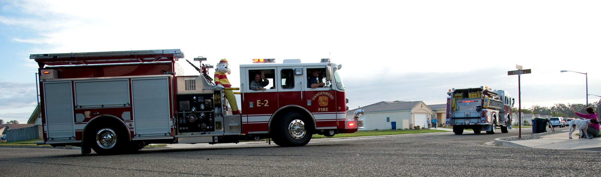 VANDENBERG AIR FORCE BASE, Calif. – Sparky, the Vandenberg Fire Department mascot, waves to the crowd from Fire Engine 2 during the Fire Prevention Parade through base housing here Thursday evening, Oct. 11, 2012. The Fire Prevention Parade was one of the key events the Vandenberg Fire Department hosted during Fire Prevention Week Oct. 7-13. (U.S. Air Force photo/Senior Airman Lael Huss)