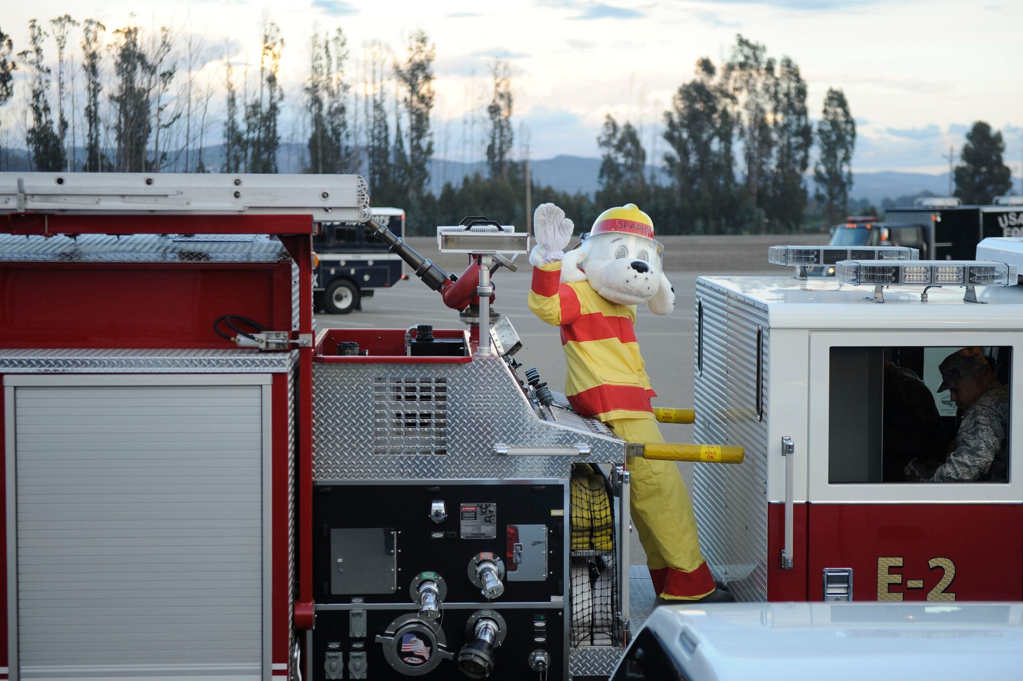 VANDENBERG AIR FORCE BASE, Calif. – Sparky, the Vandenberg Fire Department mascot, waves as parade vehicles assemble for the Fire Prevention Parade through base housing here Thursday, Oct. 11, 2012. The Fire Prevention Parade was one of the key events the Vandenberg Fire Department hosted during Fire Prevention Week Oct. 7-13. (U.S. Air Force photo/Airman Veronique Henry)