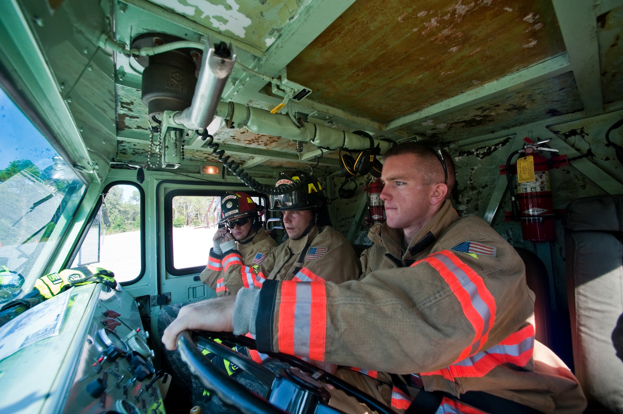 U.S. Air Force Airmen from the 1st Special Operations Mission Support Group fight on real fire burns during firefighter training on Hurlburt Field, Fla., Oct. 11, 2012. Squadron leadership trained on how to use a vehicle-mounted water turret to extinguish a fire at a simulated C-130 crash site. (U.S. Air Force photo/Airman 1st Class Christopher Williams)