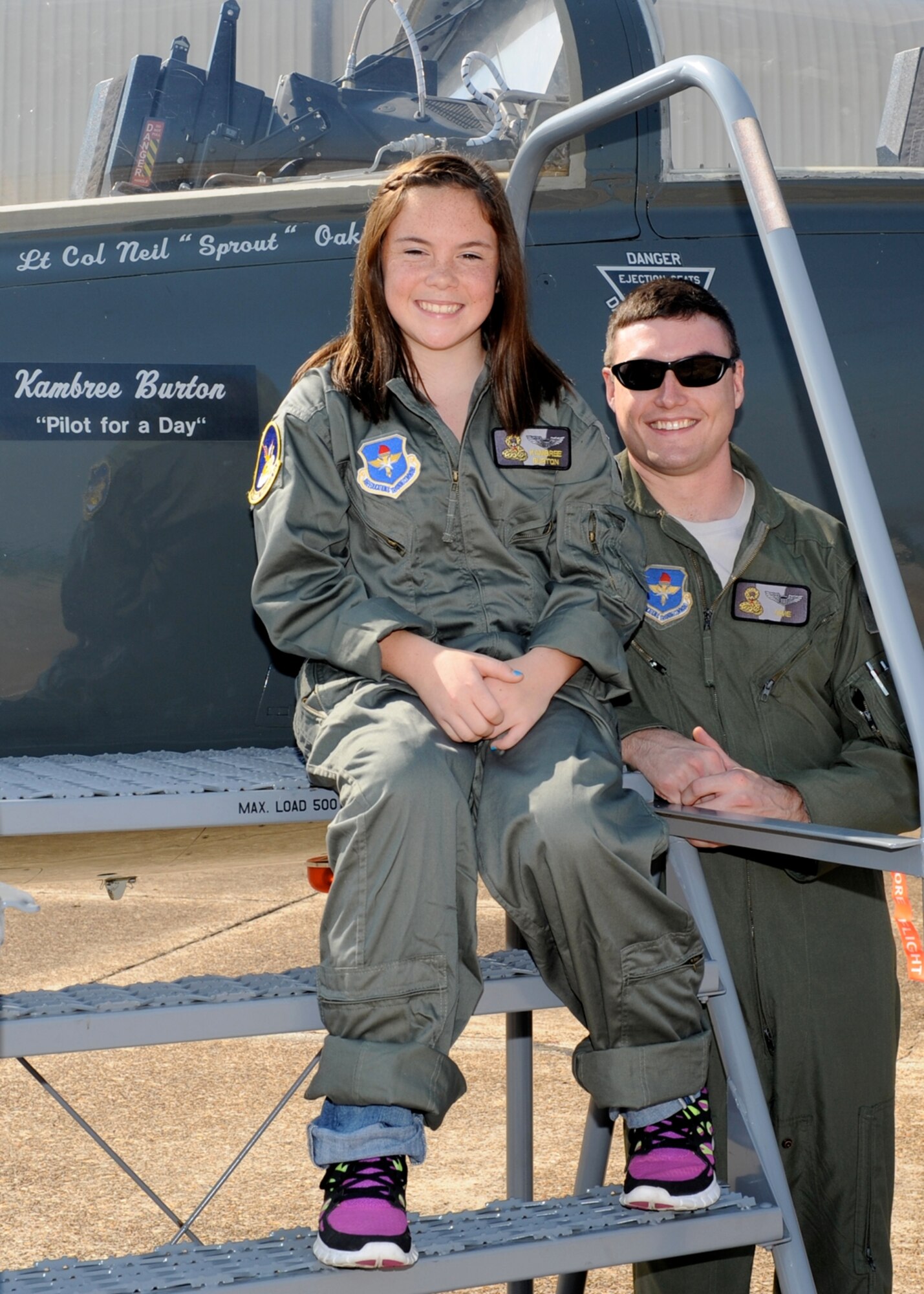 Kambree Burton, a patient at Blair E. Baston for Children in Jackson, Miss. became a pilot for a day thanks to Columbus Air Force Base.  During her time as a pilot, escorted by 1st Lt. Bryan Hladik, Pilot for a Day program coordinator, Burton participated in a T-38C simulator, saw Military Working Dogs in action, took a tour of the RAPCON, rode on a fire truck and more.  (U.S. Air Force Photo/Elizabeth Owens)
