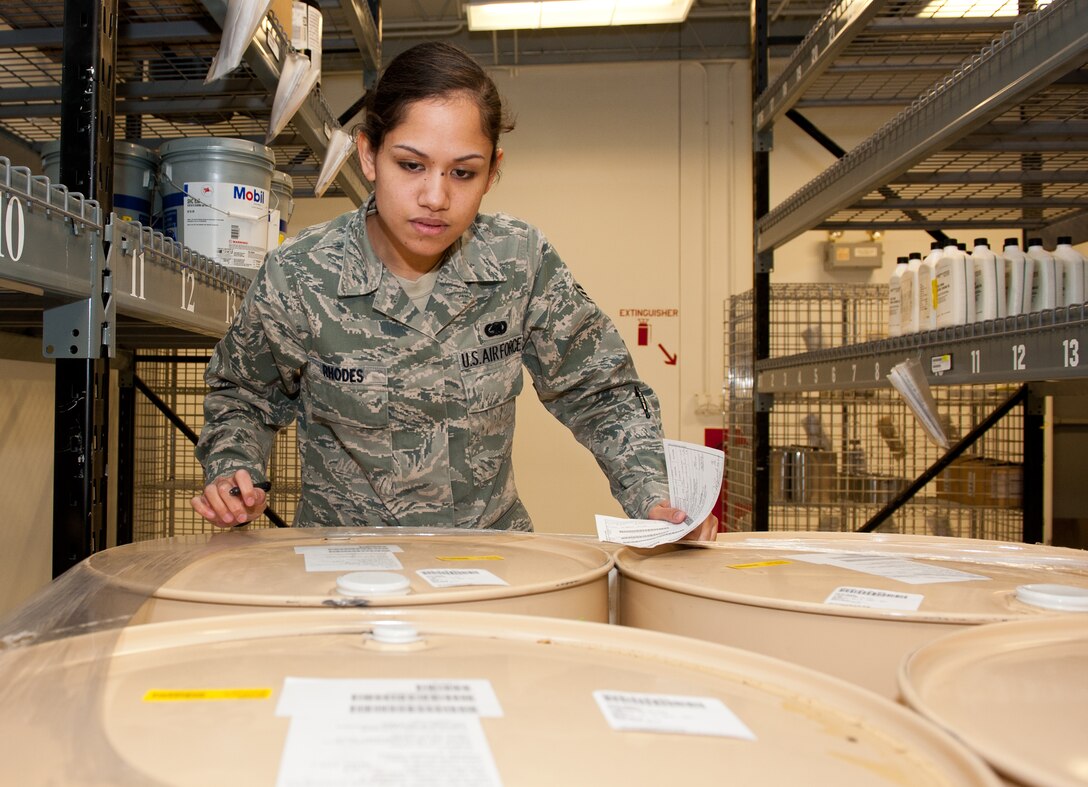 Airman 1st Class Jessie Rhodes, 28th Logistics Readiness Squadron central storage technician, checks the expiration dates on barrels of hydraulic fluid for a customer in the Hazardous Material Pharmacy at Ellsworth Air Force Base, S.D., Oct. 4, 2012. HAZMART consists of four functional areas: control and management, regulated distribution, material reuse and recycling, and reduction of hazardous waste. (U.S. Air Force photo by Airman 1st Class Kate Thornton-Maurer/Released) 