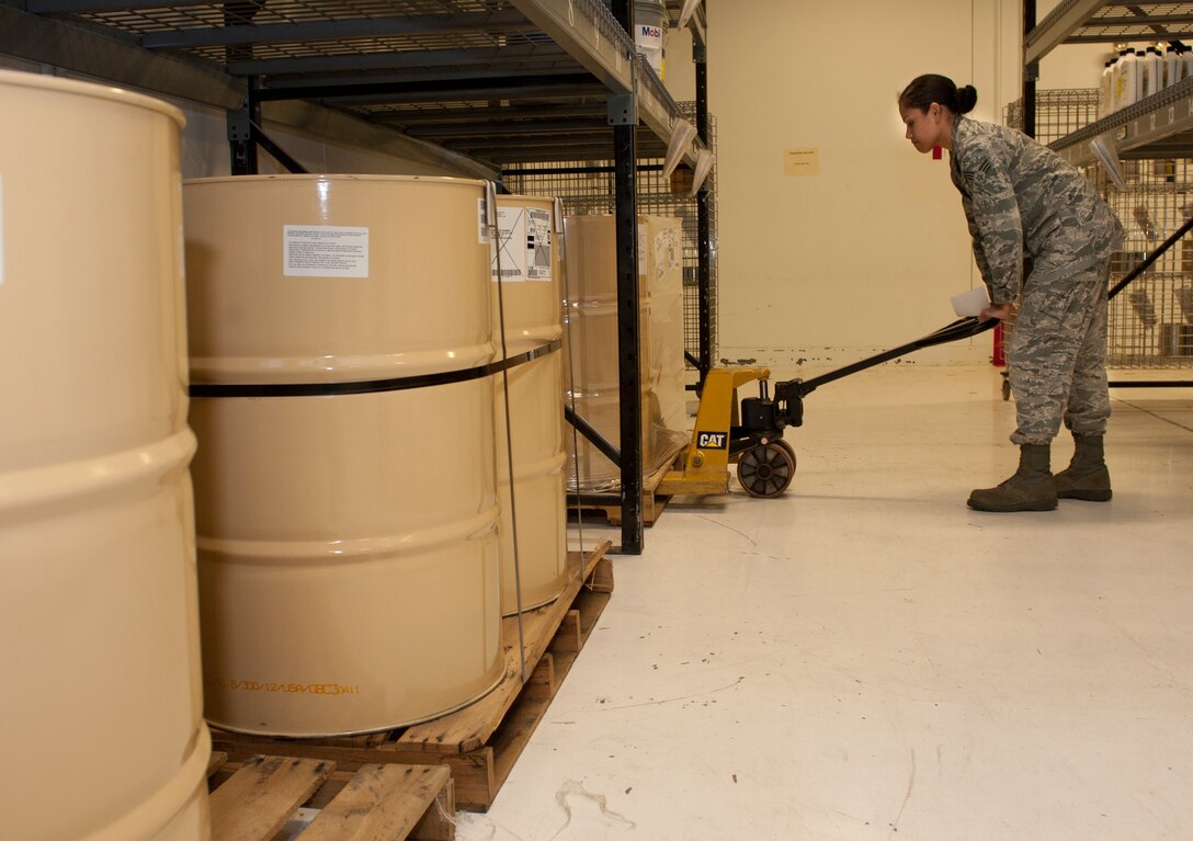Airman 1st Class Jessie Rhodes, 28th Logistics Readiness Squadron central storage technician, retrieves barrels of hydraulic fluid for a customer in the Hazardous Material Pharmacy at Ellsworth Air Force Base, S.D., Oct. 4, 2012. HAZMART Airmen provide prompt response for mission essential materials, and reduce the workload on functional organizations around base. (U.S. Air Force photo by Airman 1st Class Kate Thornton-Maurer/Released)