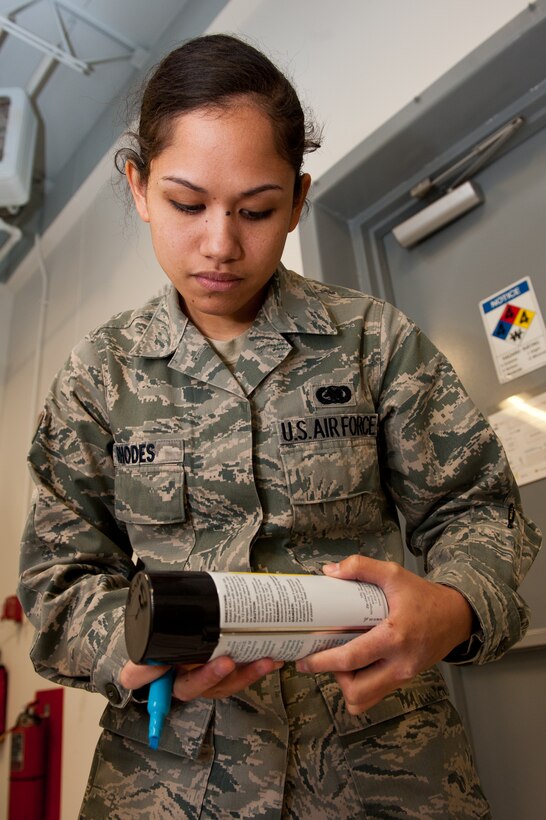 Airman 1st Class Jessie Rhodes, 28th Logistics Readiness Squadron central storage technician, inspects an aerosol can during a monthly barcode inventory in the Hazardous Material Pharmacy at Ellsworth Air Force Base, S.D., Oct. 4, 2012. HAZMART Airmen provide a single point of control for management, accountability, and tracking of the distribution and use of all hazardous materials on the base. (U.S. Air Force photo by Airman 1st Class Kate Thornton-Maurer/Released)