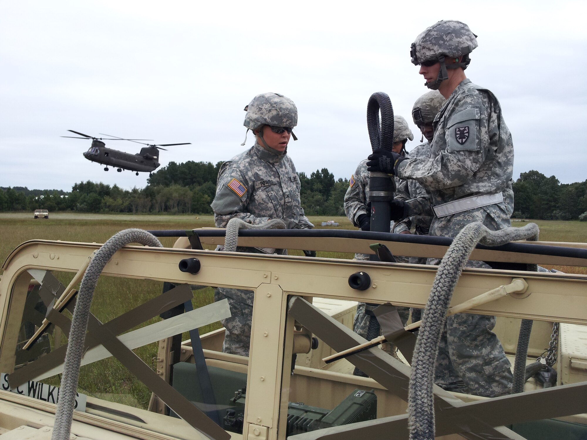 Soldiers from the 53rd Movement Control Battalion, 7th Sustainment Brigade, prepare to hook up a Humvee to a Chinook helicopter during sling-load training at Felker Army Airfield on Fort Eustis, Va., recently. Army cargo specialists are trained to prepare, rig and load equipment for transport by rail, ground, sea and air. (U.S. Army photo by Sgt. 1st Class Brian Rhodes/Released)