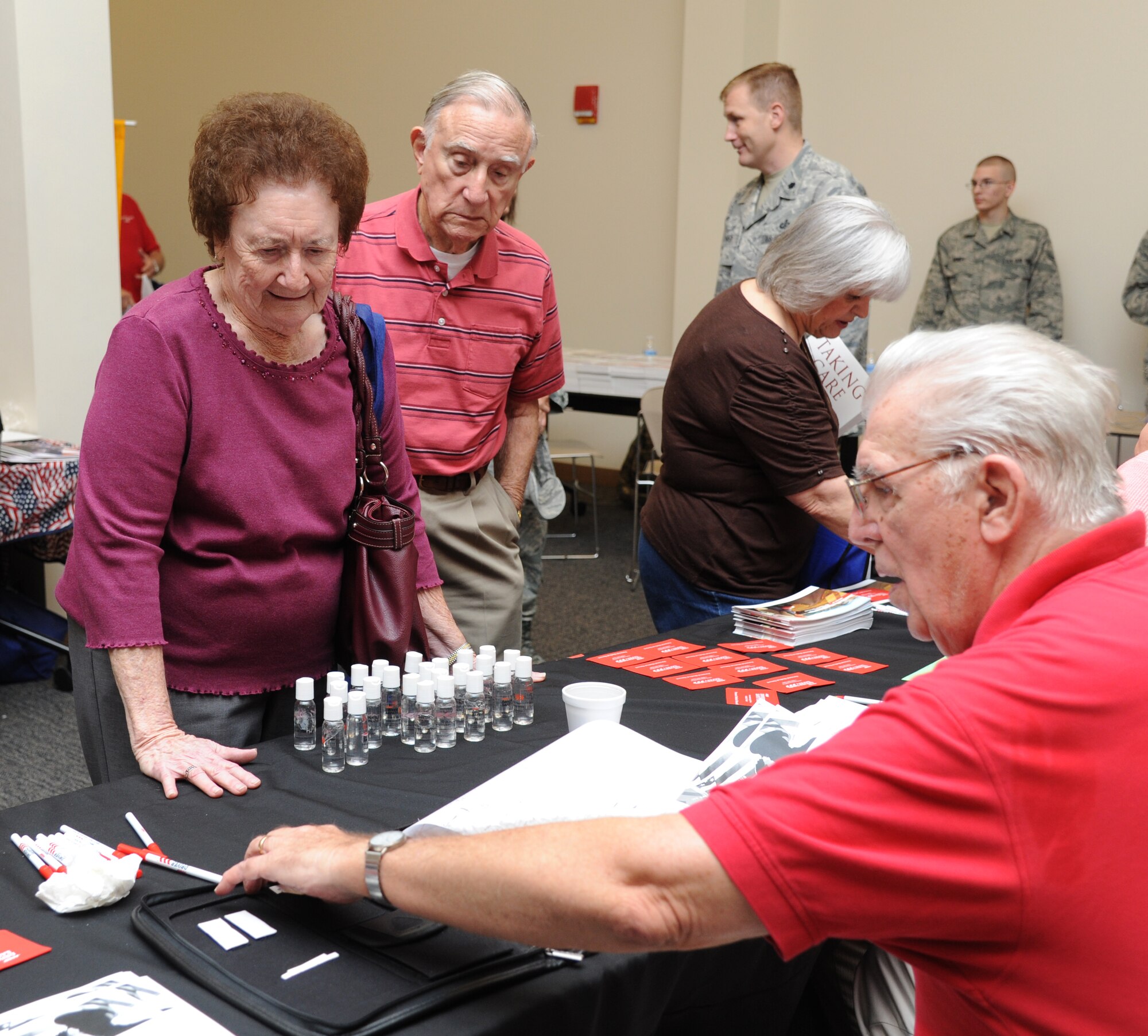 Betty and her husband, retired Master Sgt. Charles Martin of Biloxi, Miss., receives information from Bill Williams, American Association of Retired Persons, on the AARP driver safety course during the 81st Training Wing’s retiree appreciation day Oct. 12, 2012, at the Roberts Consolidated Aircraft Maintenance Facility, Keesler Air Force Base, Miss.  The event included information booths, guest speakers and lunch.  (U.S. Air Force photo by Kemberly Groue)