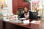 Wanda Cooper, Joint Base San Antonio-Randolph school liaison officer, answers a call at her office. (U.S. Air Force photo by Melissa Peterson)