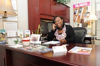 Wanda Cooper, Joint Base San Antonio-Randolph school liaison officer, answers a call at her office. (U.S. Air Force photo by Melissa Peterson)