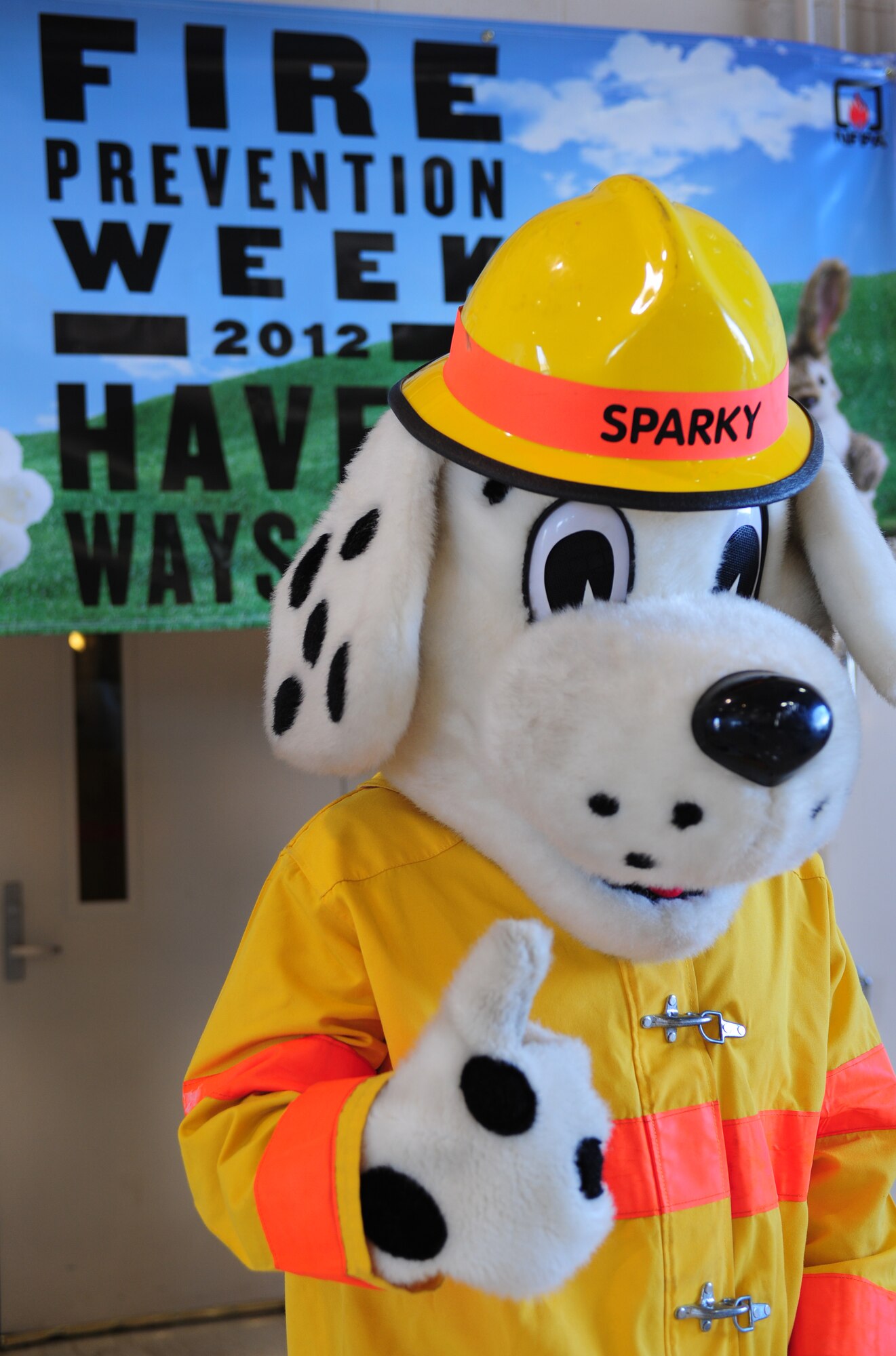 Sparky the firehouse dog stands in front of a poster promoting Fire Prevention Week during the firefighter’s open house at Cannon Air Force Base, N.M., Oct. 10, 2012. Fire Prevention Week is an annual event that is dedicated to spreading fire prevention techniques to the community and thanking those who serve and protect. (U.S. Air Force photo/Airman 1st Class Ericka Engblom)