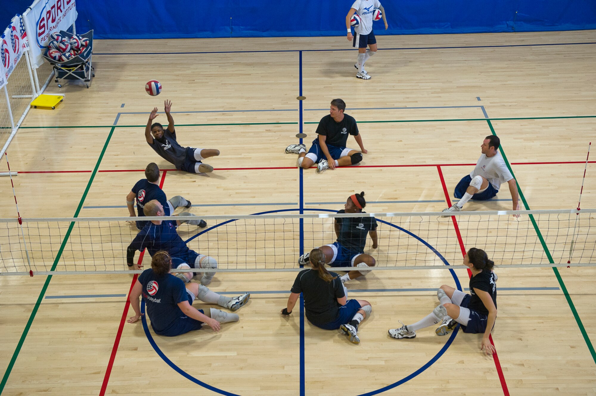 Playing a scrimmage against the male Paralympic team, Miller was named the best receiver and libero (defensive specialist) during the 2012 Paralympics in the women’s sitting volleyball event at the London Games. (Photo by Tech. Sgt. Samuel Bendet)