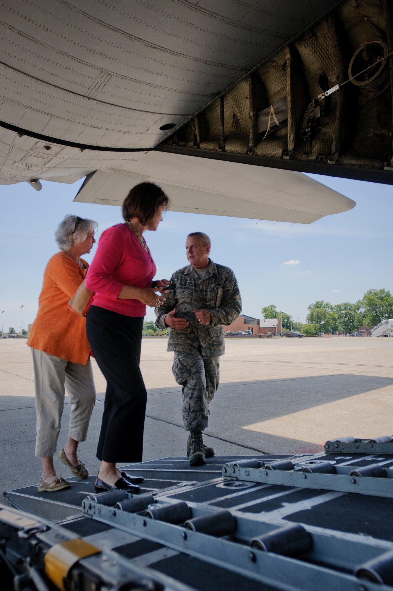 Command Chief Master Sgt. Curtis Carpenter, 123rd Airlift Wing Command Chief, speaks to Mary Moseley (left), President and Owner of Al J. Schneider Co., and Rita Reedy, Corporate Marketing Director for Al J. Schneider Co, while boarding a Kentucky Air National Guard C-130 at Scott Air Force Base on June 8. The employers were invited by the ESGR as part of a bosslift, where employers learn the importance of the U.S. Air Force mission being conducted by their traditional Guardsman employees. (U.S. Air Force photo by Master Sgt. Phil Speck)