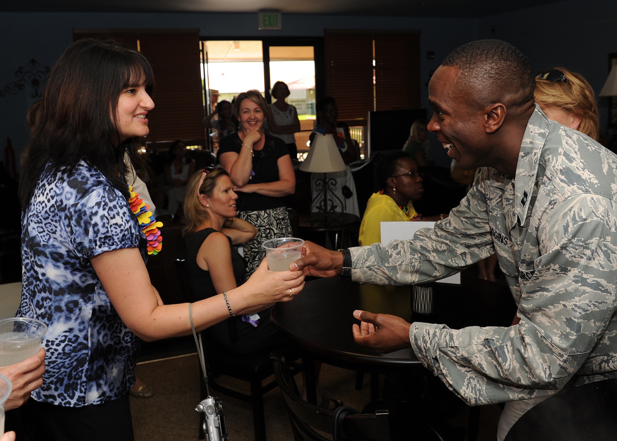 Capt. Anthony Wigging, 647th Air Base Group chaplain and Gathering Place coordinator, hands out Hawaiian Breeze clubs soda to a spouse from the foreign attaché corps at The Gathering Place, a comfortable alcohol- and smoke-free home-like environment where young Airmen can socialize with their peers at the Hickam dormitories on Joint Base Pearl Harbor-Hickam, Hawaii, Oct. 9, 2012. Lt. Gen. Frank Gorenc, U.S. Air Force assistant vice chief of staff, hosted the tour which is meant to showcase how the U.S. Air Force conducts business.  The tour for the spouses highlighted how PACAF houses its forces, develops Airmen’s dependent children and cares for wounded members, common topics among the world’s militaries. (U.S. Air Force Photo/Tech. Sgt. Jerome S. Tayborn/Released)