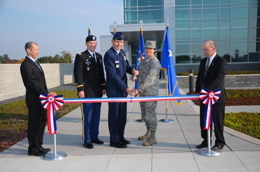 Cutting the ribbon during the unveiling of the Air Force Life Cycle Management Center’s new $33 million Information Technology Complex Oct. 5 at Wright-Patterson Air Force Base are (L-R): Randyll Levine, ITC director and chief; Col. Luke Leonard, commander, U.S. Corps of Engineers, Louisville District; Lt. Gen. CD Moore II, AFLCMC commander; Col. Cassie Barlow, 88th Air Base Wing commander; and Kevin Cozart, operations vice president of Messer Construction Co.  (Skywrighter photo by Niki Jahns) 