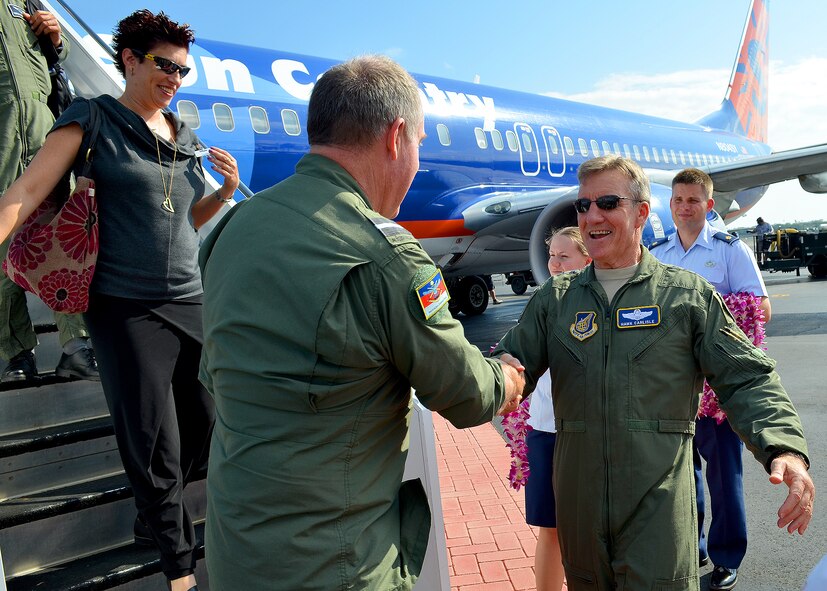 An Australian officer from the Royal Australian Air Force is greeted by Gen. Herbert J. “Hawk” Carlisle, Pacific Air Forces commander, at base operations, Joint Base Pearl Harbor-Hickam, Hawaii, Oct. 7, 2012.  Lt. Gen. Frank Gorenc, U.S. Air Force assistant vice chief of staff, hosted the tour to demonstrate to the foreign air attaché leaders and their spouses how the U.S. Air Force conducts business.  The trip highlighted how Air Force installations operate through mission briefing hands-on demonstrations. (U.S. Air Force Photo/Tech. Sgt. Jerome S. Tayborn/Released)