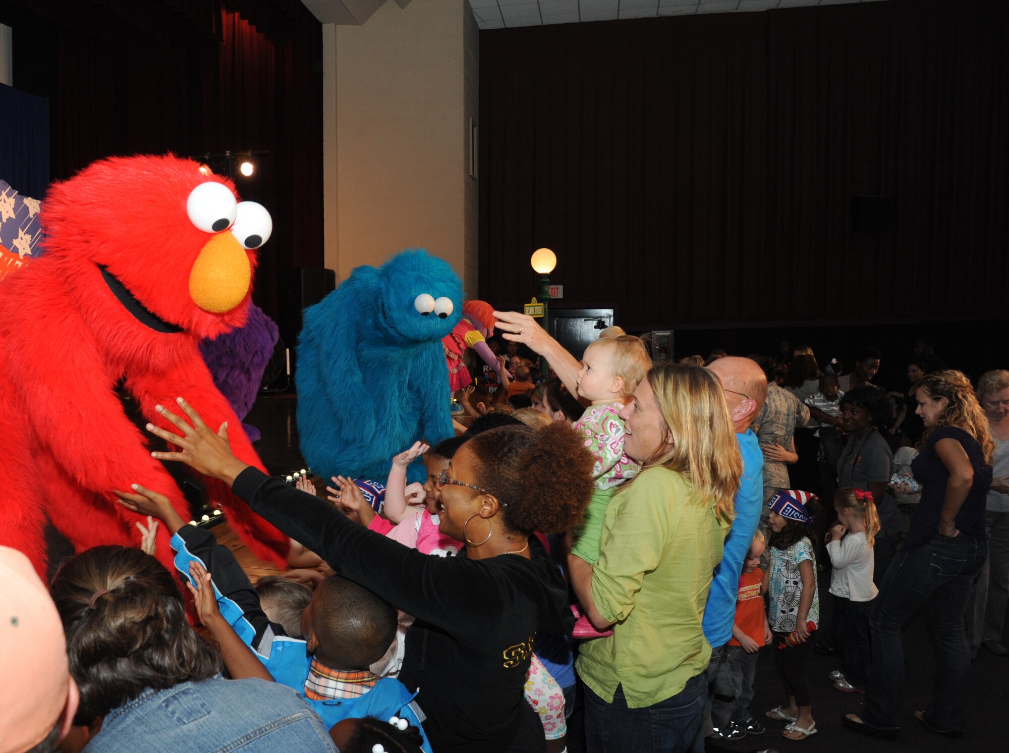Children cheer as Sesame Street characters arrive during the Sesame Street/USO Experience for Military Families show Oct. 9, 2012 at the Welch Theater, Keesler Air Force Base, Miss.  The 45-minute family-oriented event hosted by the 81st Force Support Squadron includes a character named Katie who is a military child.  With the help of her Sesame pals, Katie learns to deal with her fears and excitement about relocating.  The show emphasizes the importance of adjusting to change and the power of friendship.  (U.S. Air Force photo by Kemberly Groue)