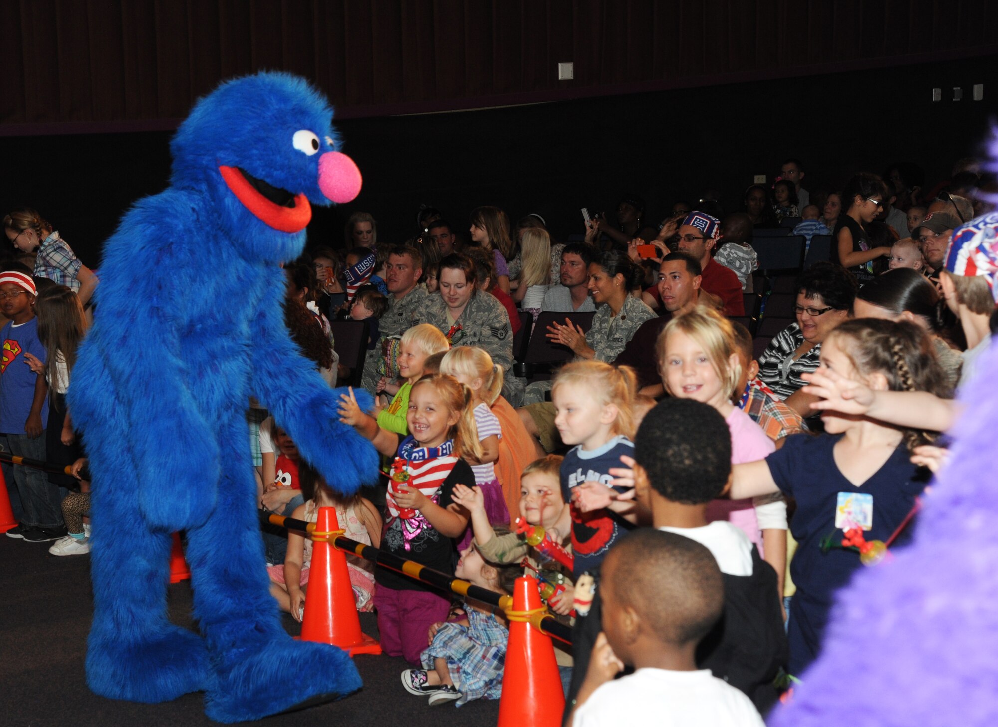Children cheer as Sesame Street characters arrive during the Sesame Street/USO Experience for Military Families show Oct. 9, 2012 at the Welch Theater, Keesler Air Force Base, Miss.  The 45-minute family-oriented event hosted by the 81st Force Support Squadron includes a character named Katie who is a military child.  With the help of her Sesame pals, Katie learns to deal with her fears and excitement about relocating.  The show emphasizes the importance of adjusting to change and the power of friendship.  (U.S. Air Force photo by Kemberly Groue)