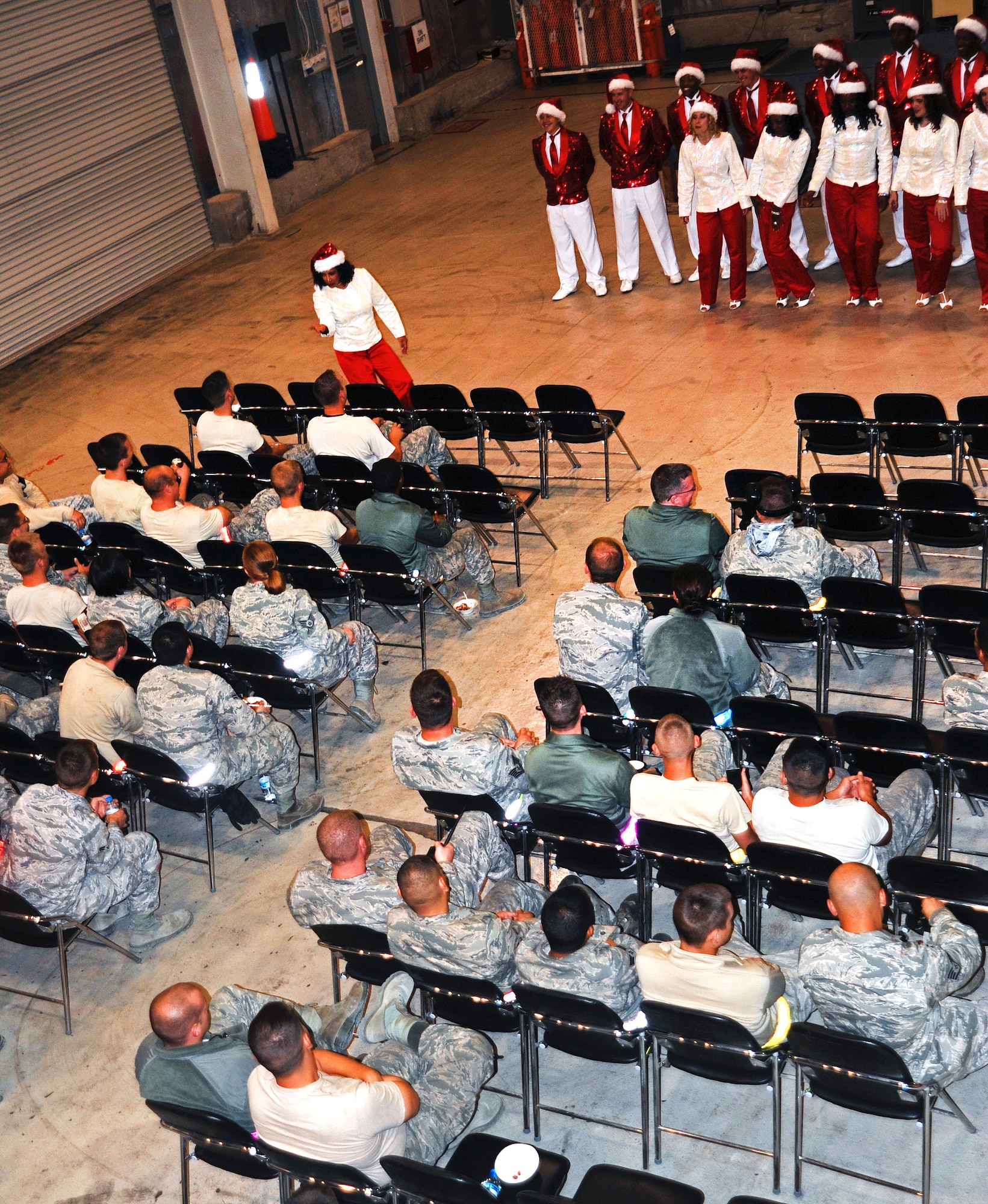 Staff Sgt. Abigail Foster, 92nd Maintenance Squadron and former Tops in Blue vocalist, sings for 380th Air Expeditionary Wing maintainers in a hangar giving them a break from the flightline during their “Holiday Tour.” Tops in Blue performs nearly 150 shows, with 25 to 30 of them at deployed locations. (U.S. Air Force photo by Staff Sgt. J.G. Buzanowski) 