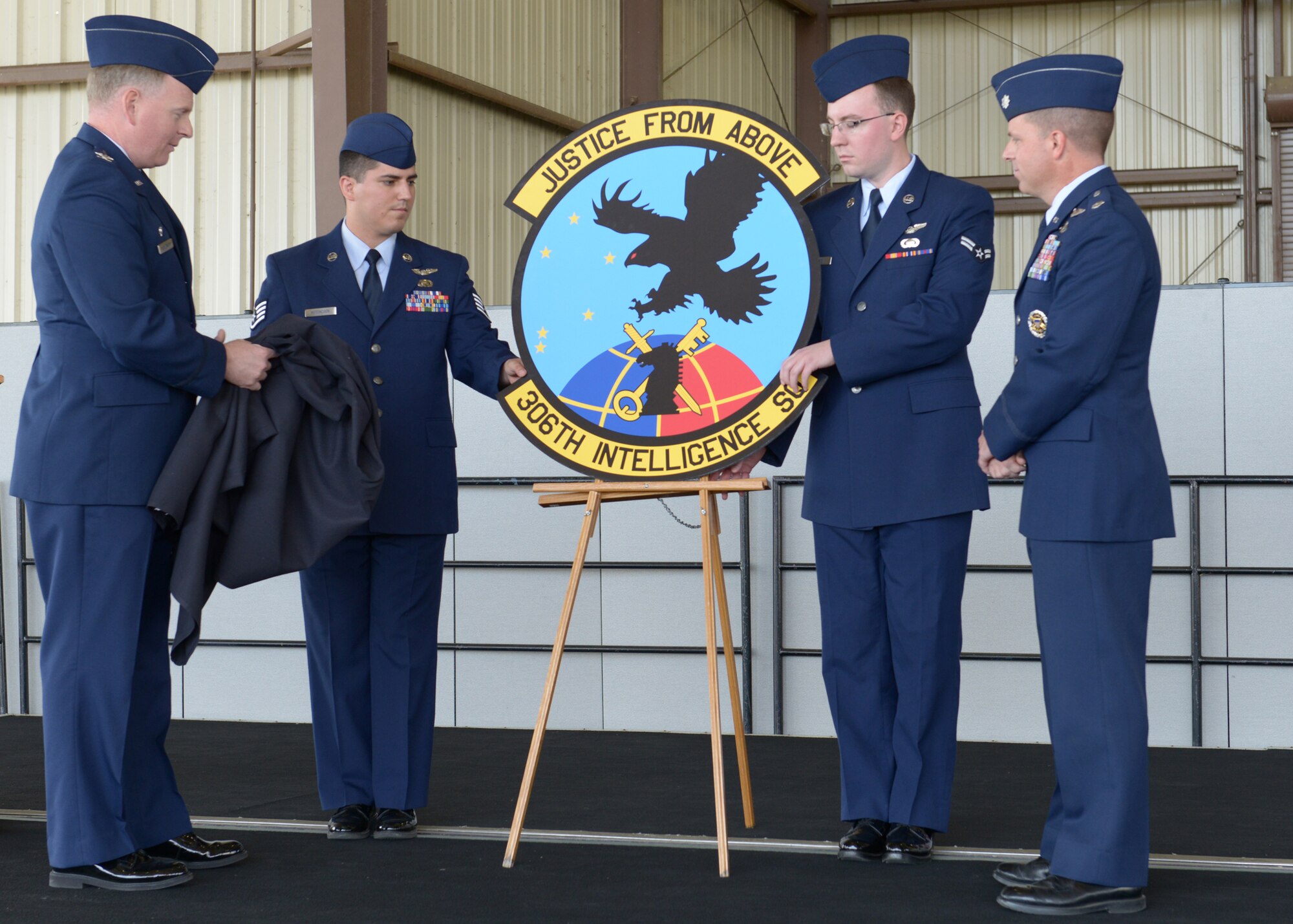 BEALE AIR FORCE BASE, Calif. -- Col. Michael Stevenson (left), 361st Intelligence, Surveillance and Reconnaissance Group commander, admires the new squadron patch of the newly activated 306th Intelligence Squadron here, Oct. 5. Each part of the patch, which says “Justice From Above,” signifies a function of the squadron. (U.S. Air Force photo by John Schwab)  