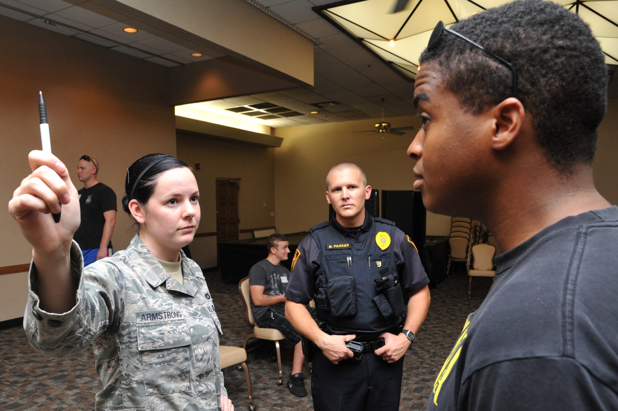 Airman 1st Class Camree Armstrong, 56th Security Forces Squadron security patrol, performs a horizontal gaze nystagmus test on Staff Sgt. Miles Smith, 56th Equipment Maintenance Squadron, Sept. 28 during a driving under the influence enforcement training course held at Bldg. 750 at Luke Air Force Base, Ariz. The course was put on by the Arizona Governor’s Office of Highway Safety and sponsored by the City of Prescott’s Police Department.   (U.S. Air Force photo by Senior Airman Sandra Welch)