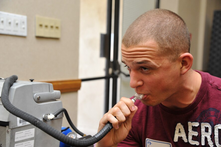 Airman 1st Class Jordan Straessle, 56th Component Maintenance Squadron fuels shop, blows into a breathalyzer Sept. 28 to determine his breath alcohol concentration during a driving under the influence enforcement training course held at Bldg. 750 at Luke Air Force Base, Ariz. The three-day course was designed for students to see and test live intoxicated subjects.  (U.S. Air Force photo by Senior Airman Sandra Welch)