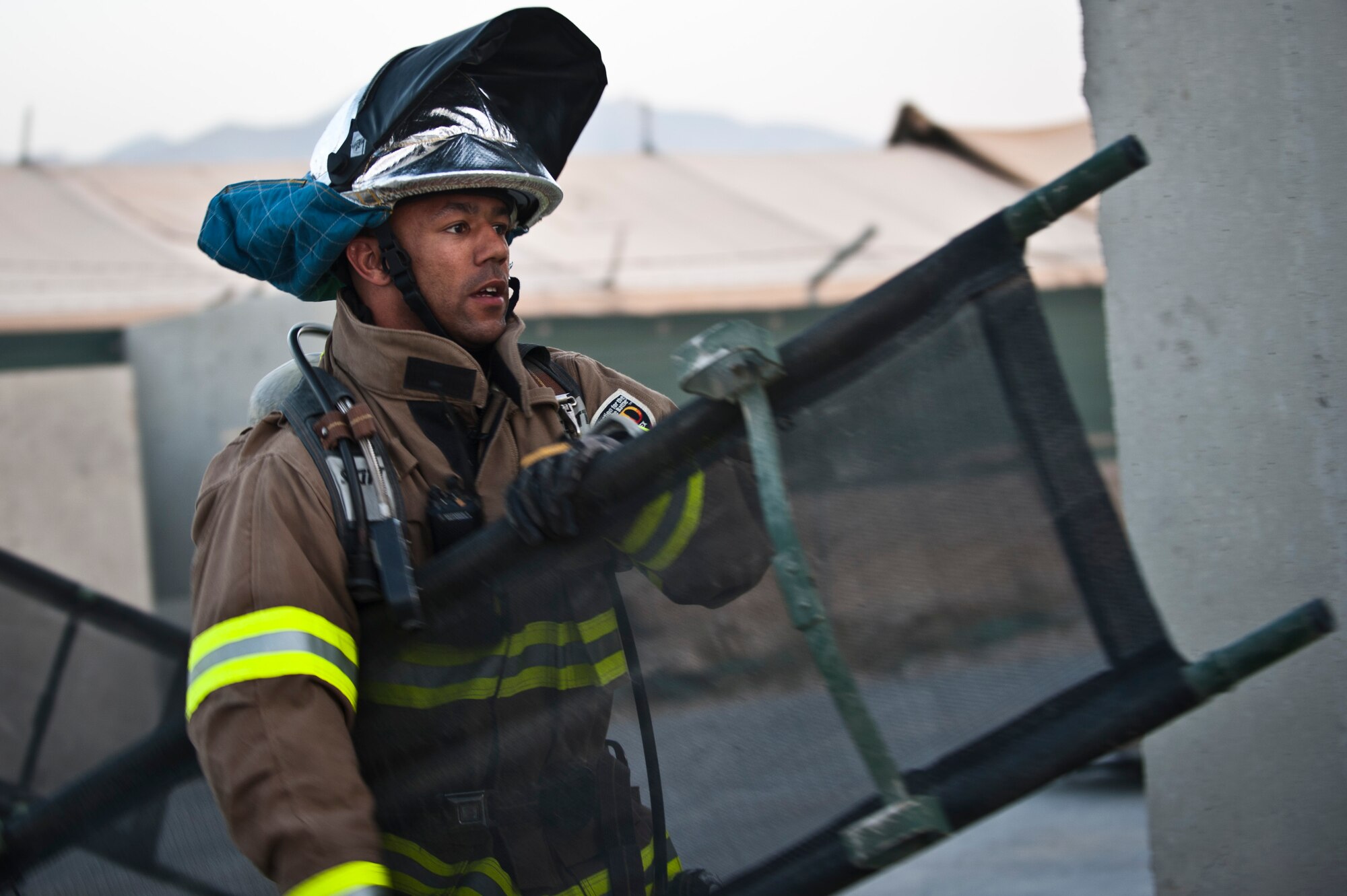 A Firefighter carries a litter into a dining facility during an emergency response exercise at Bagram Airfield, Afghanistan, Oct. 12, 2012. The base conducts regular joint exercises to ensure effective interoperability between Air Force and Army emergency crews on Bagram. (U.S. Air Force photo/Capt. Raymond Geoffroy)