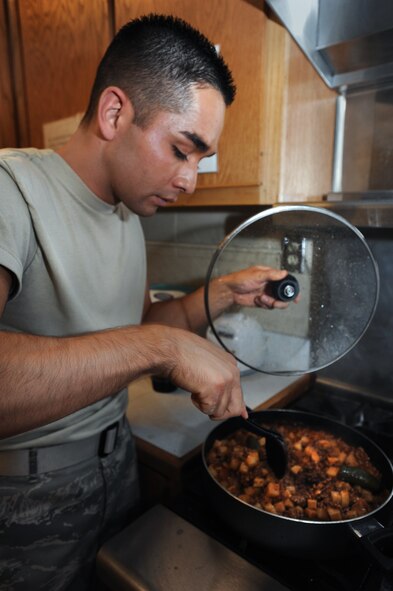 U.S. Air Force Airman 1st Class Alexxis Pons Abascal, 27th Special Operations Wing Public Affairs, stirs "picadilla", a meat and potato dish, during the "buen provecho" cooking class for Hispanic Heritage Month at Cannon Air Force Base, N.M., Oct. 10, 2012. After the class all who attended were able to sit down at a table together to taste this authentic Mexican cuisine. (U.S. Air Force illustration/Senior Airman Jette Carr)
