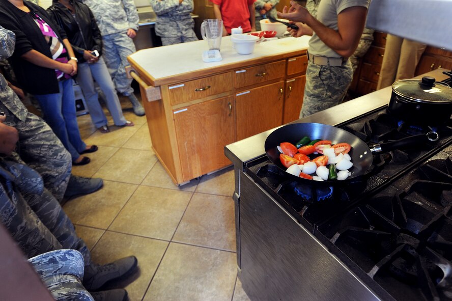 U.S. Air Force Airman 1st Class Alexxis Pons Abascal, 27th Special Operations Wing Public Affairs, instructs those attending the "buen provecho" cooking class for Hispanic Heritage Month at Cannon Air Force Base, N.M., Oct. 10, 2012. After the class all who attended were able to sit down at a table together to taste this authentic Mexican cuisine. (U.S. Air Force photo/Senior Airman Jette Carr)