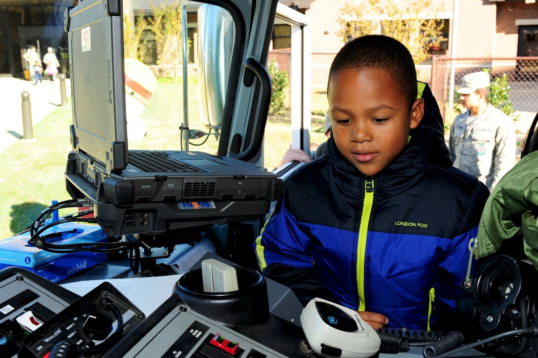 Anthony Chapman checks out the electronic system in the front seat of a fire truck during a Fire Prevention Week demonstration at the Bethel Youth Programs center, Hampton, Va., Oct. 11, 2012. The 633rd Civil Engineer Squadron fire fighters visited various locations on-and-off base to express the importance of alternate escape routes and fire safety tips. (U.S. Air Force photo by Staff Sgt. Ashley Hawkins/Released)