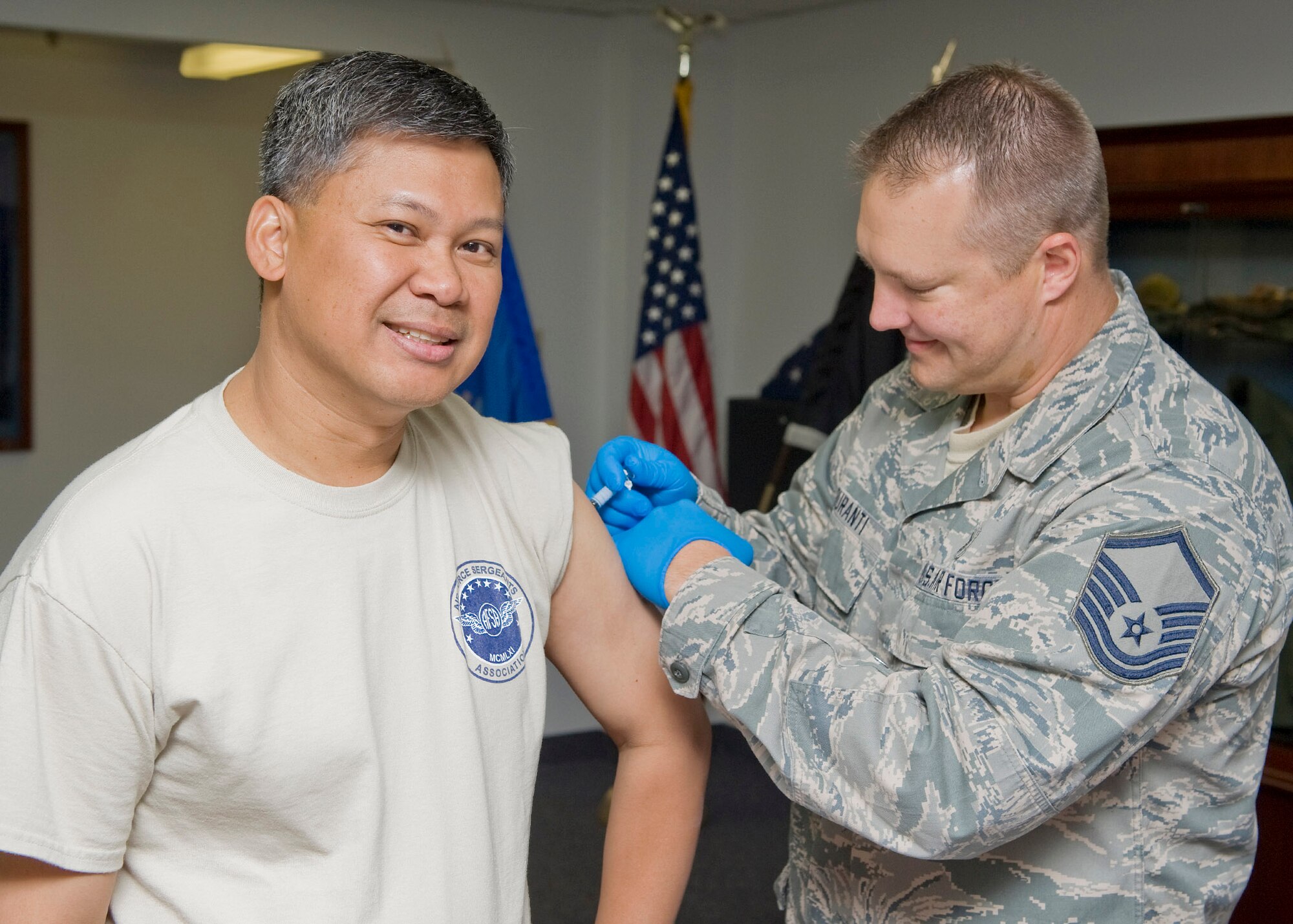Master Sgt. Anthony Duranti, 341st Medical Operations Squadron immunizations technician, administers a flu shot to Col. H.B. Brual, 341st Missile Wing commander, on Oct. 4.  The Influenza vaccination is currently available to all active-duty Airmen on base every week day at the immunization clinic between the hours of 7:30 a.m. and 4 p.m.  The flu vaccination will be available for all retirees and dependants starting Oct. 15.  No appointments are needed. (U.S. Air Force photo/Beau Wade)
