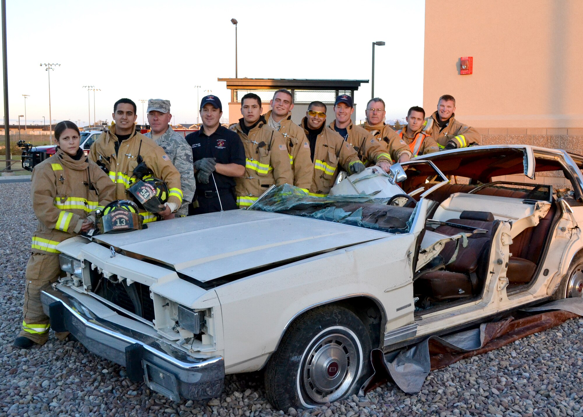 Several Malmstrom fire fighters pose for a photo following their auto extrication demonstration.  The demo was one of several events the fire department held in celebration of Fire Prevention Week to promote fire safety.  (U.S. Air Force photo/Airman 1st Class Cortney Paxton) 