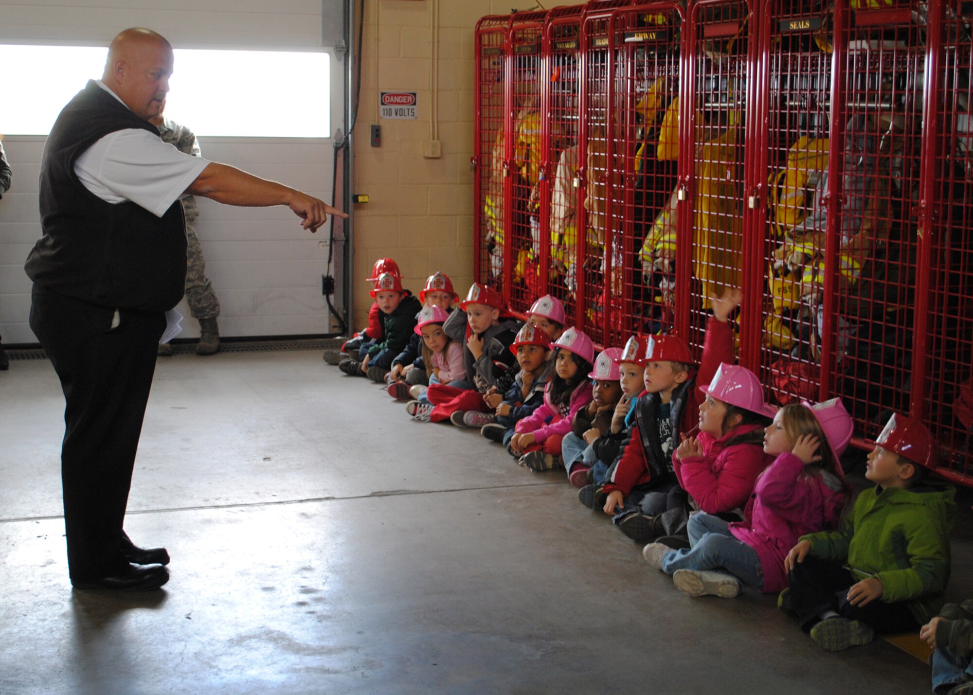 Rickey Naccarato, 341st CES assistant chief of fire prevention, calls on children to answer questions about fire prevention to end their tour of the fire department.  The Loy Elementary School kindergarteners toured Malmstrom’s Fire Department in celebration of Fire Prevention Week.  (U.S. Air Force photo/Airman 1st Class Cortney Paxton)