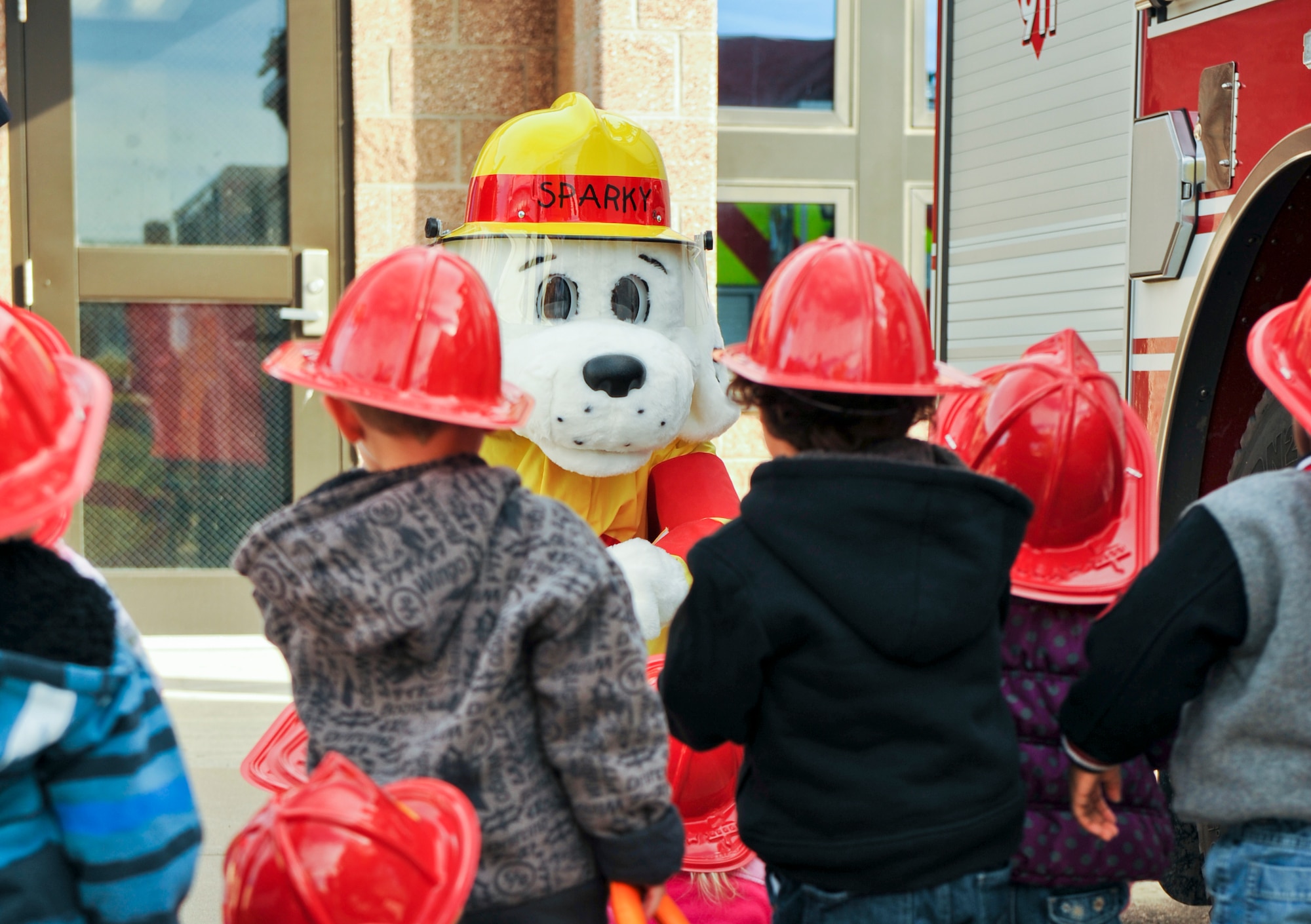 BUCKLEY AIR FORCE BASE, Colo. – Sparky the Fire Dog talks with children Oct. 11, 2012, at a Buckley Child Development Center. Fire department members taught children valuable fire prevention tips to follow in case of an emergency. (U.S. Air Force photo by Senior Airman Christopher Gross)