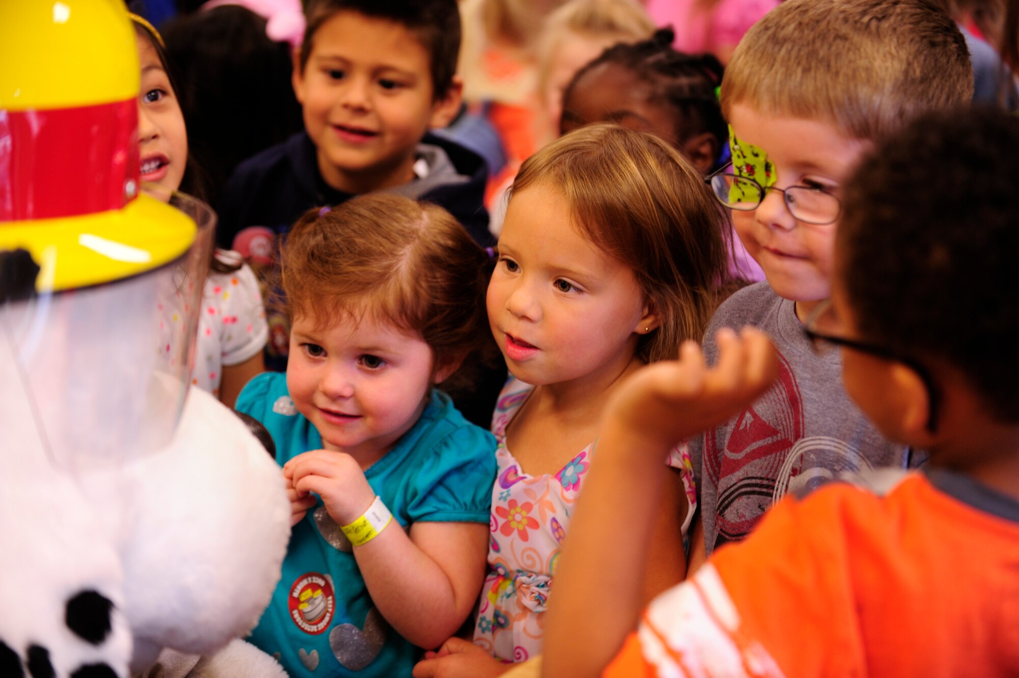 VANDENBERG AIR FORCE BASE, Calif. – Children at the Child Development Center crowd around Sparky, Vandenberg Fire Department mascot, during his tour here Wednesday, Oct. 10, 2012. Sparky and Smokey the Bear visited the children to kick-off Fire Prevention Week.  (U.S. Air Force photo/Senior Airman Lael Huss)