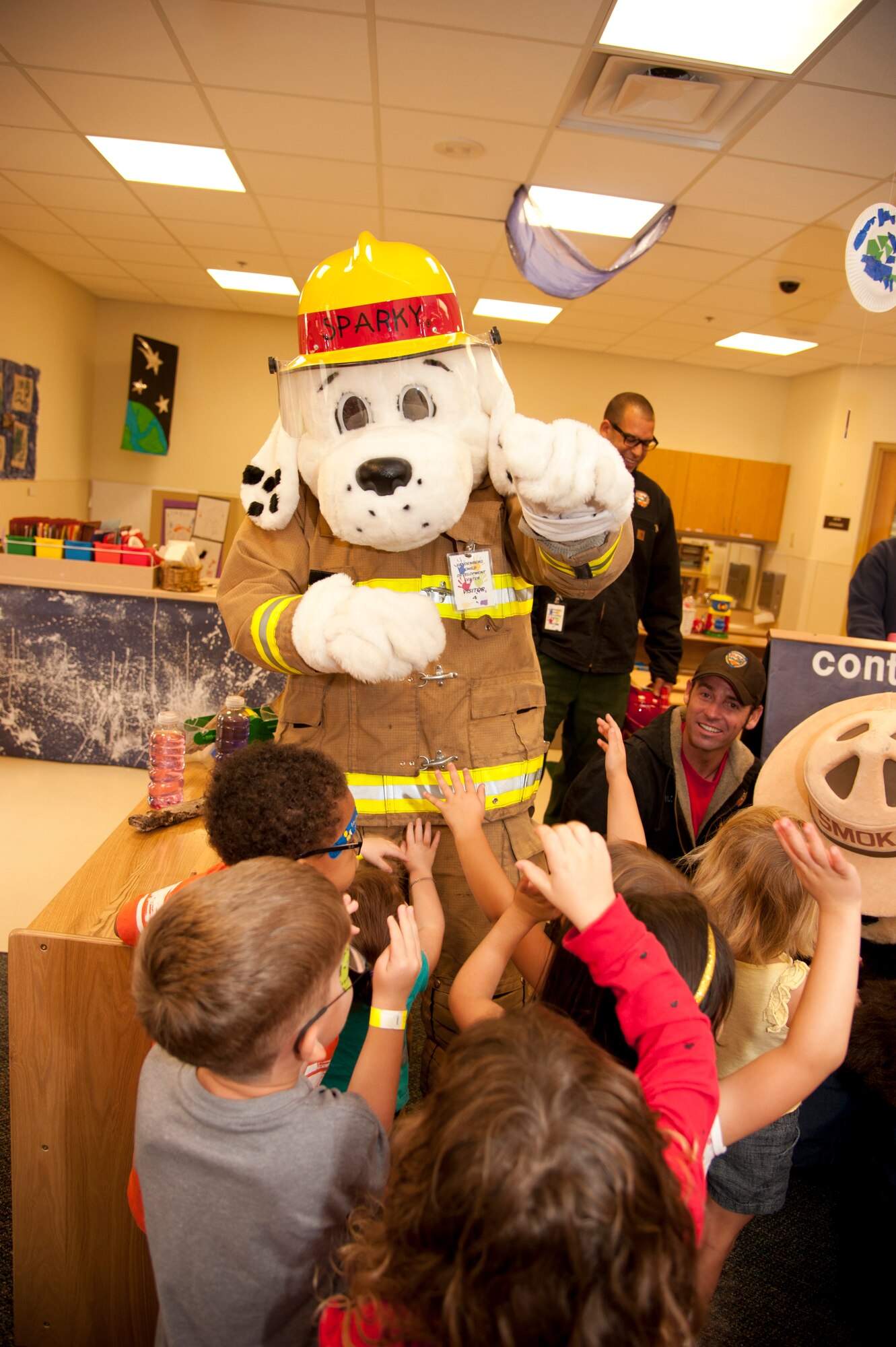 VANDENBERG AIR FORCE BASE, Calif. – Sparky, Vandenberg Fire Department mascot, waves goodbye to the three and four year-olds at the Child Development Center here Wednesday, Oct. 10, 2012. Sparky and Smokey the Bear visited the CDC to kick-off Fire Prevention Week going on between October 7-13.  (U.S. Air Force photo/Senior Airman Lael Huss)