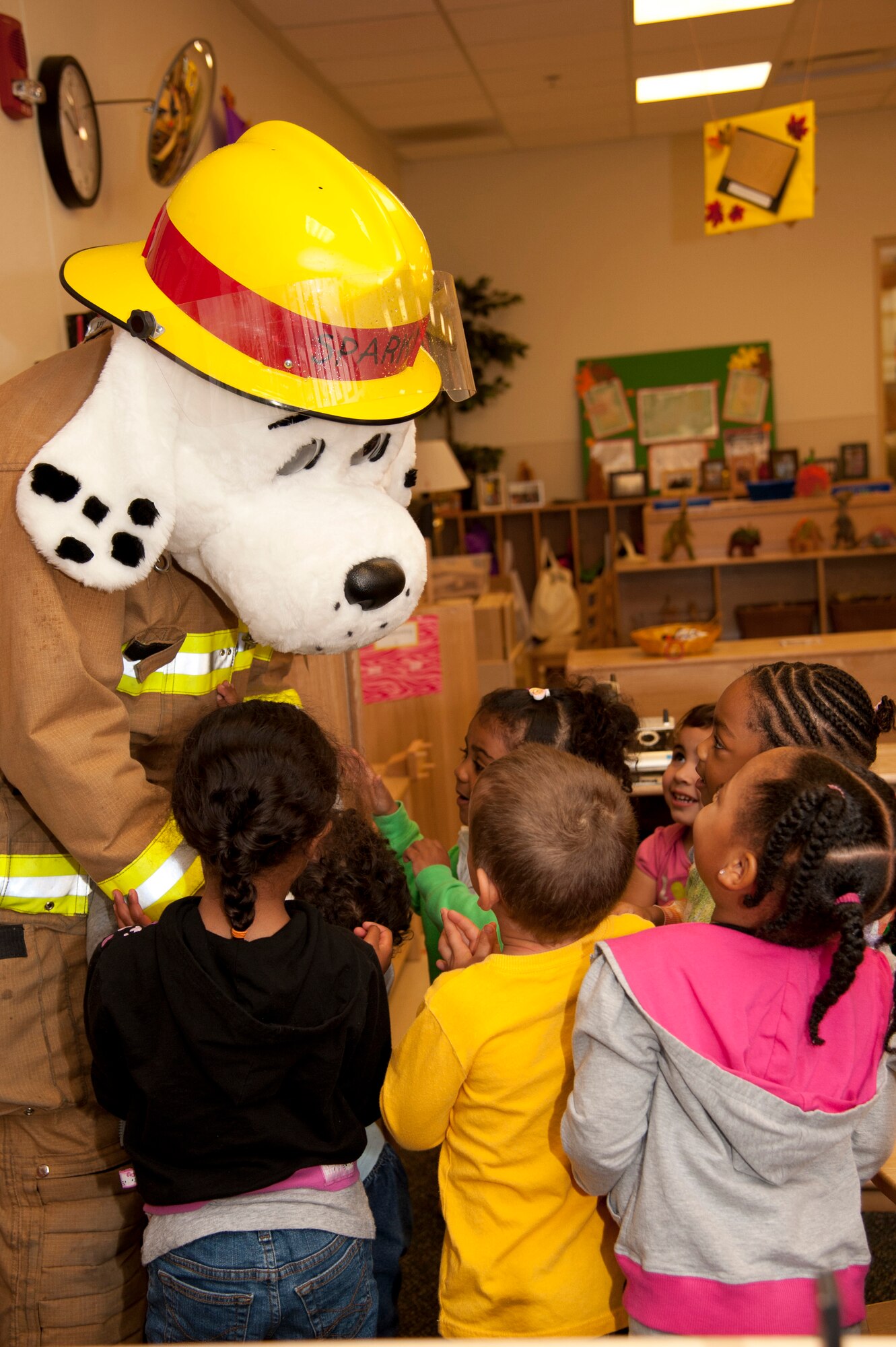 VANDENBERG AIR FORCE BASE, Calif. – Sparky, Vandenberg Fire Department mascot, greets children during a tour of the Child Development Center here Wednesday, Oct. 10, 2012. Sparky and Smokey the Bear visited the children to kick-off Fire Prevention Week on base. (U.S. Air Force photo/Senior Airman Lael Huss)
