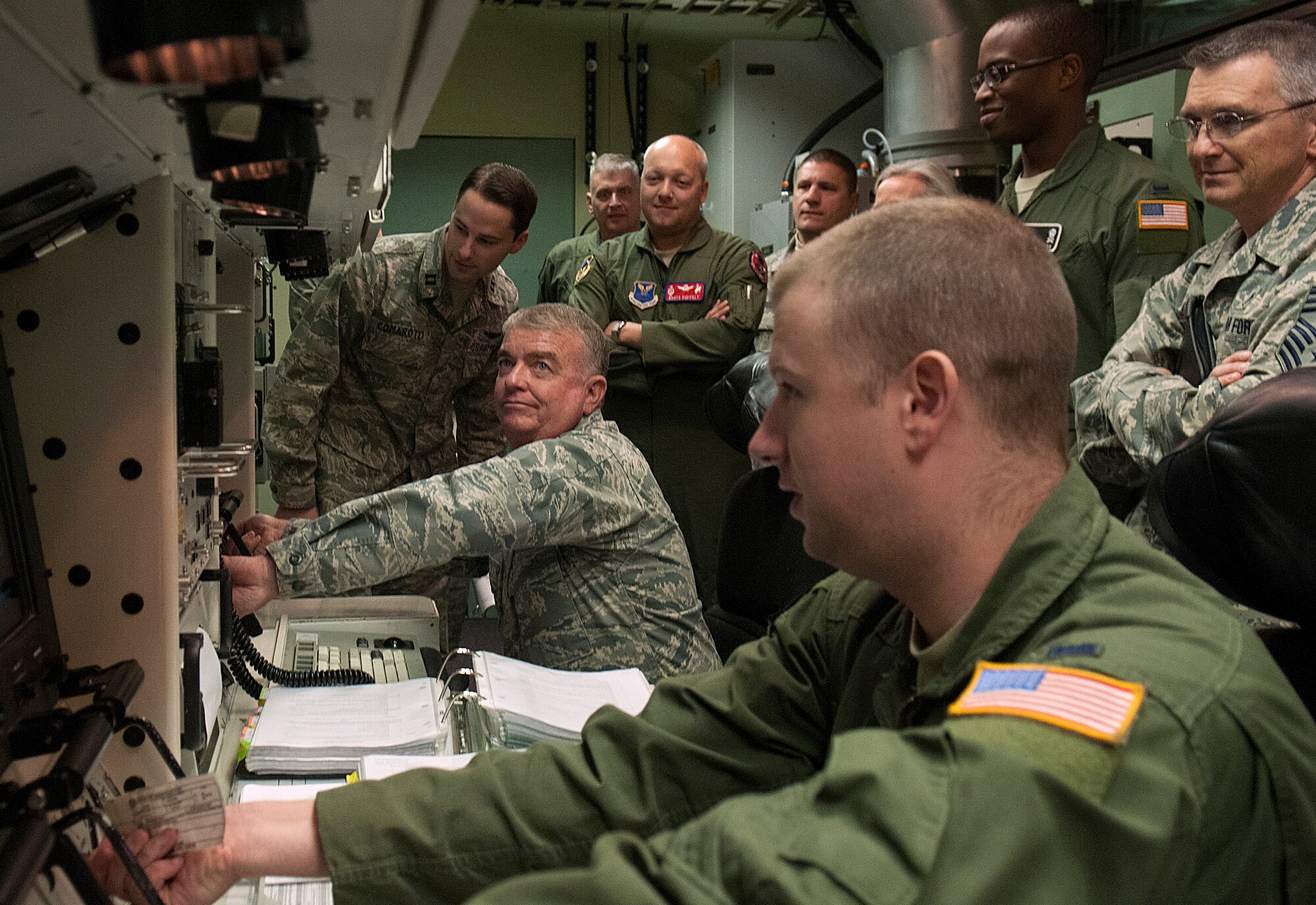 Lt. Gen. Thomas Travis, U.S. Air Force Surgeon General, turns the keys during a simulated launch in the 90th Operations Support Squadron’s missile procedures trainer Oct. 4. Capt. Paul Comaroto, 90th OSS, coached Travis as 1st Lt. Ian Gunther, 90th Operations Group, turned the second set of keys. Accompanying Travis on his visit to the MPT was Col. Christopher Coffelt, 90th Missile Wing Commander, Chief Master Sgt. Michael Garrou, 90 MW command chief and, far right, Chief Master Sgt. Kevin Lambing, chief medical enlisted force. (U.S. Air Force photo by R.J. Oriez)