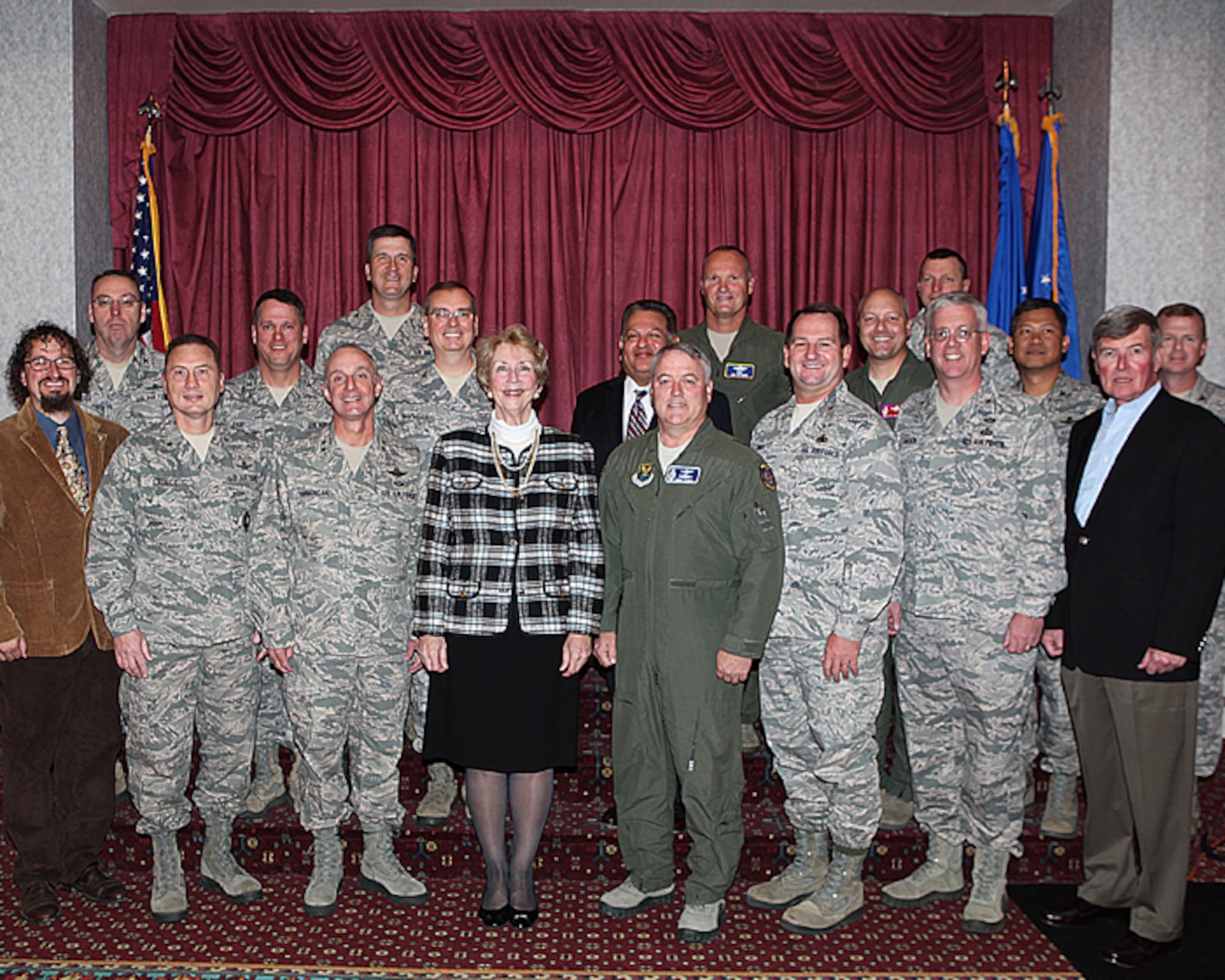 Ann Mitchell, Air Force Global Strike Command Director of Logistics, Installations and Mission Support, and Maj. Gen. Michael Carey, 20th Air Force commander, pose for a group photograph with members of the General Officer Steering Group Oct. 3, at Trails End Club. The GOSG provides a forum to establish partnerships, while increasing communication and building trust - all factors essential to keeping the Airmen working on the ICBM fleet and industry leaders in the same loop. (U.S. Air Force photo by Matt Bilden)