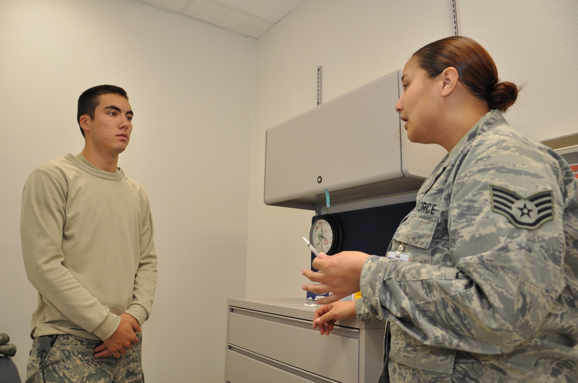 Staff Sgt. Kimberly Kretsch, 90th Medical Operations Squadron, briefs Airman 1st Class Reid Bird, 90th Missile Security Forces Squadron, before administering a flu vaccine Oct. 5 in the 90th Medical Group’s Immunizations Clinic. (U.S. Air Force photo by Senior Airman Dan Gage)