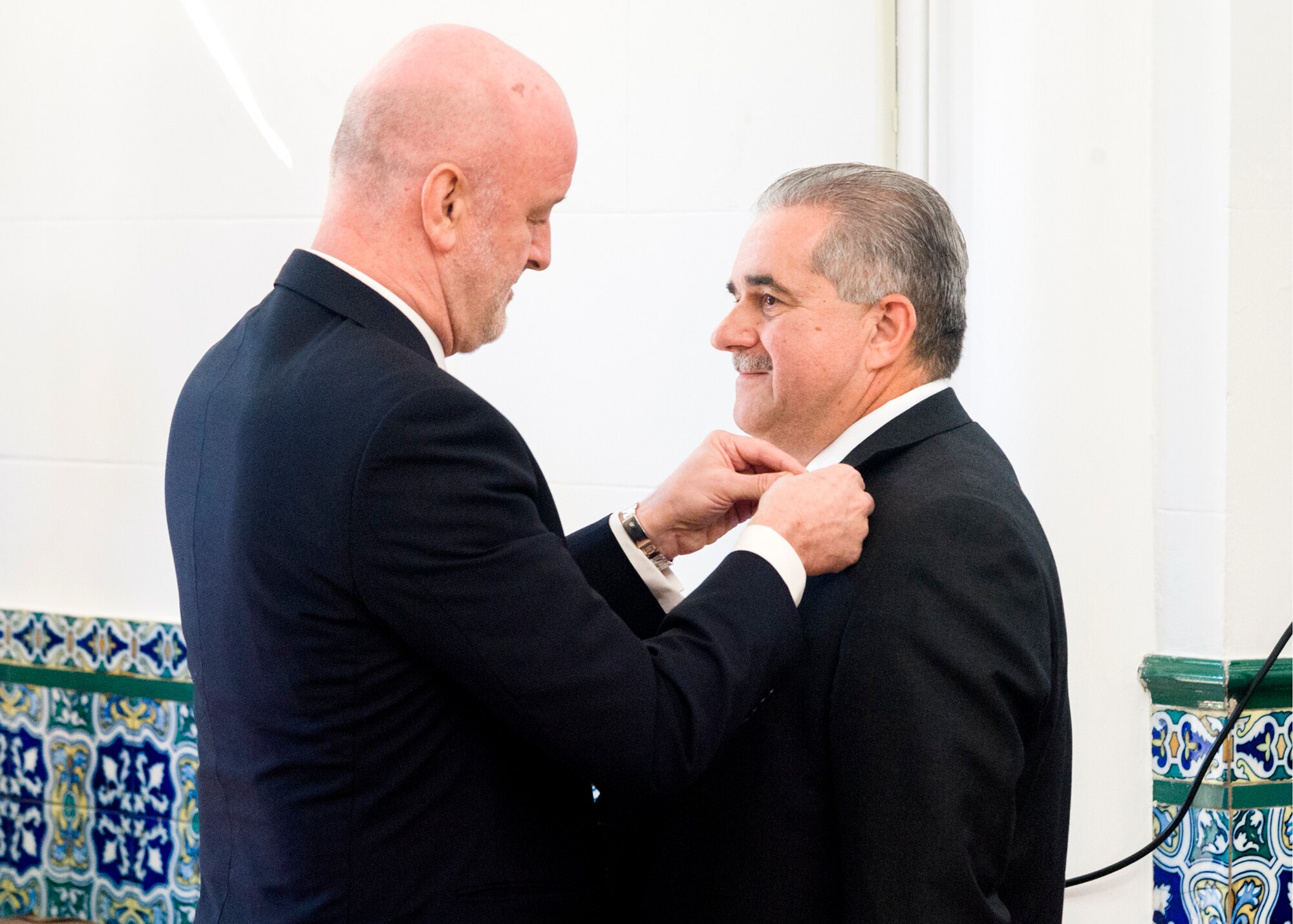 Special Agent Thomas Gozzo, right, receives the Orden Del Merito Policial with condecoration Cruz Blanca (translated:  The police Order of Merit, White Cross) from the Spanish Ambassador, His Excellency Ramon Gil-Casares October 11. (U.S. Air Force Photo by Mike Hastings.)