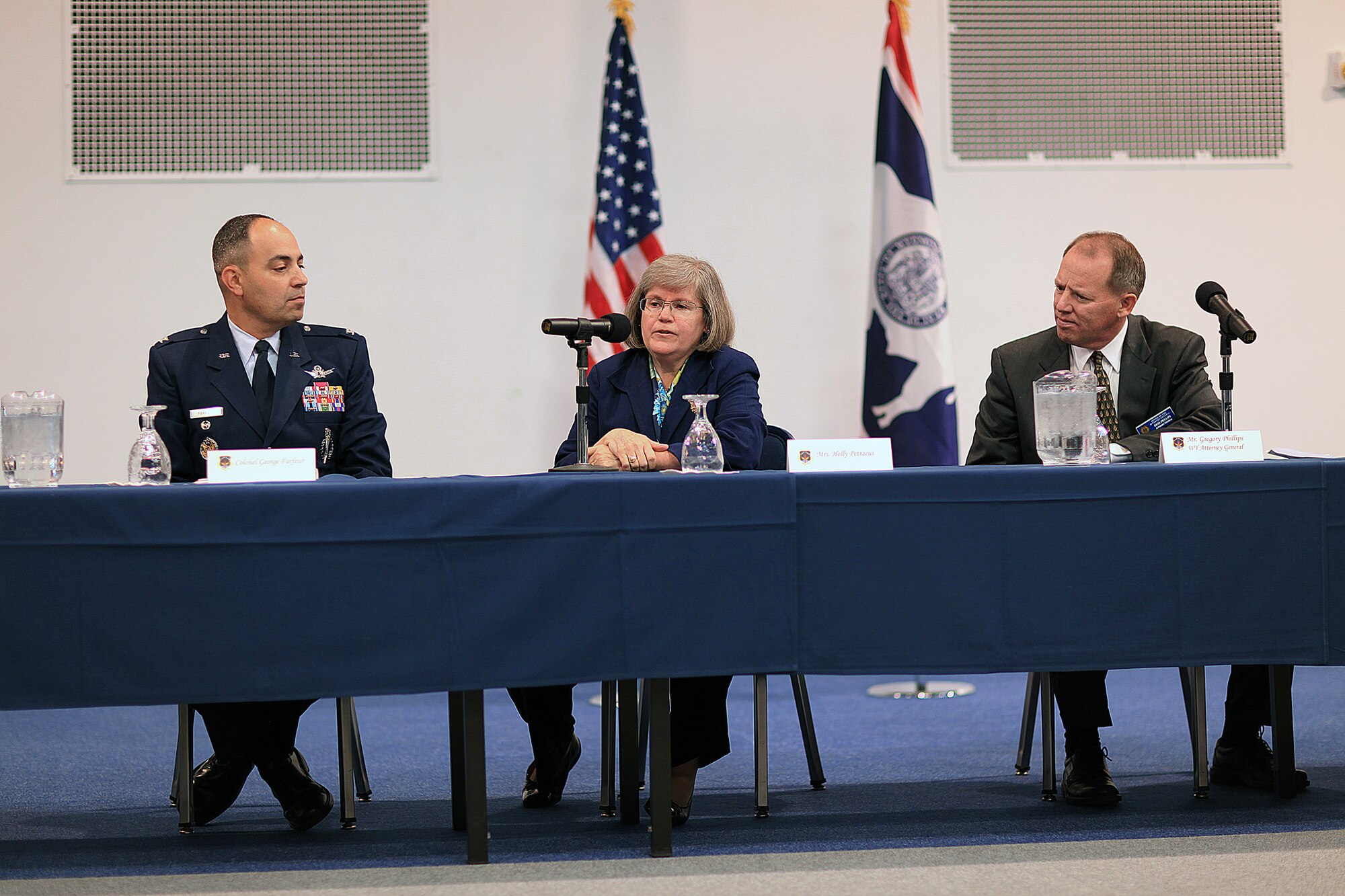 Holly Petraeus,  Servicemember Affairs Consumer Financial Protection Bureau assistant director, speaks to members of the  press  as Col. George Farfour, 90th Missile Wing vice commander, and Gregory Phillips, Wyoming Attorney General, look on. The press conference was held at Fall Hall followed by a town hall meeting Oct. 3. (U.S. Air Force photo by Matt Bilden)