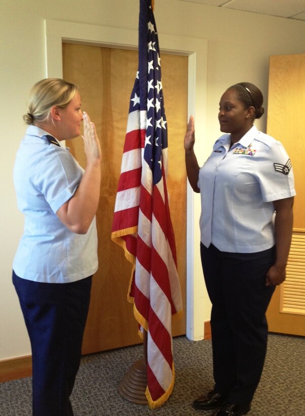 Senior Airman Jasmine Green, right, receives the oath of reenlistment from 2nd Lt. Jamie Warfield. Both Airmen are assigned to the 45th Force Support Squadron. (Courtesy Photo)
