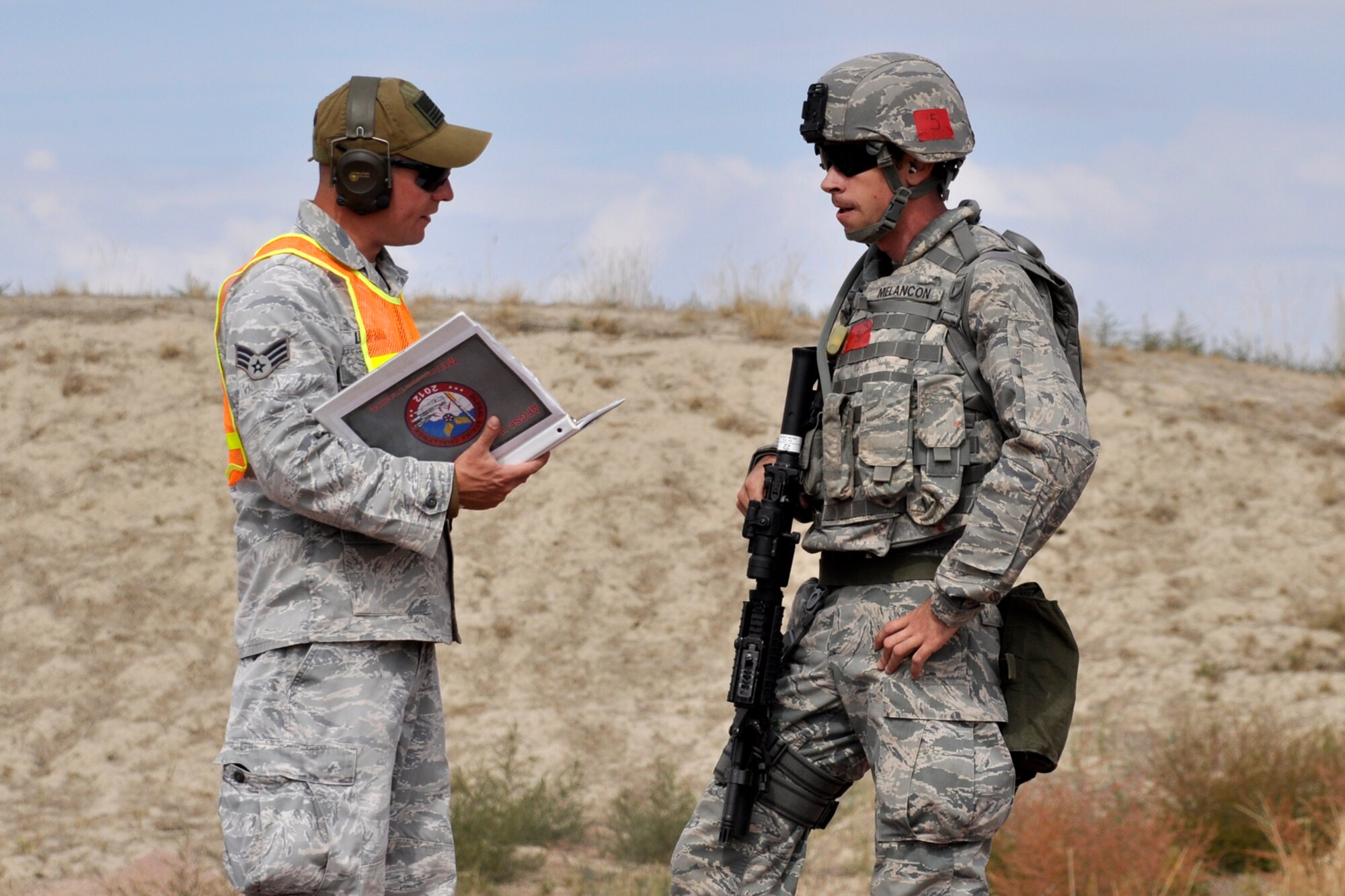 Senior Airman Clint Melancon, a 307th Security Forces Squadron journeyman from Barksdale Air Force Base, La., speaks with an evaluator at Camp Guernsey, Wyo., Sept. 25. 2012. Melancon was part of the 307 SFS team competing in the 2012 annual Global Strike Challenge. A team of six Airmen and one alternate were allowed to compete from missile and bomb wings throughout the Air Force Global Strike Command. (U.S. Air Force photo by Col. Kevin Wolfe/Released) 