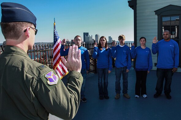 Col. Craig Peters, 911th Airlift Wing commander, enlists 4 recruits and re-enlists one Airman on top of the Duquesne Incline, Mount Washington, Pittsburgh, Pa, Oct. 11, 2012. Three of the newly enlisted members will serve at the 911th AW, and two will be part of the 910th Airlift Wing in Youngstown. After the successful completion of both Military Basic Training and Technical Training, the Airmen report to their units where they will play a significant role in the Air Force Reserve mission readiness. (U.S. Photo by Tech. Sgt. Ralph Van Houtem/Released)